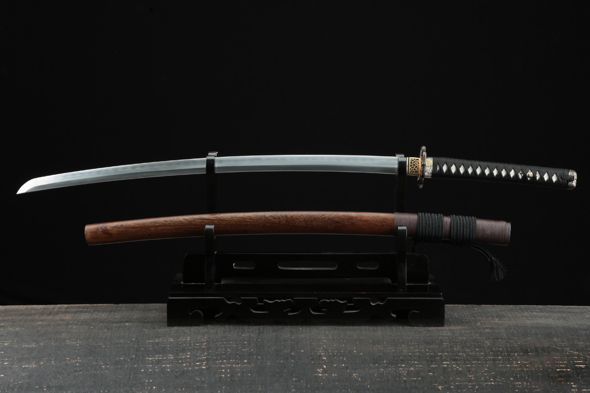 Damascus steel katana with chicken wing wood saya, displayed on a stand