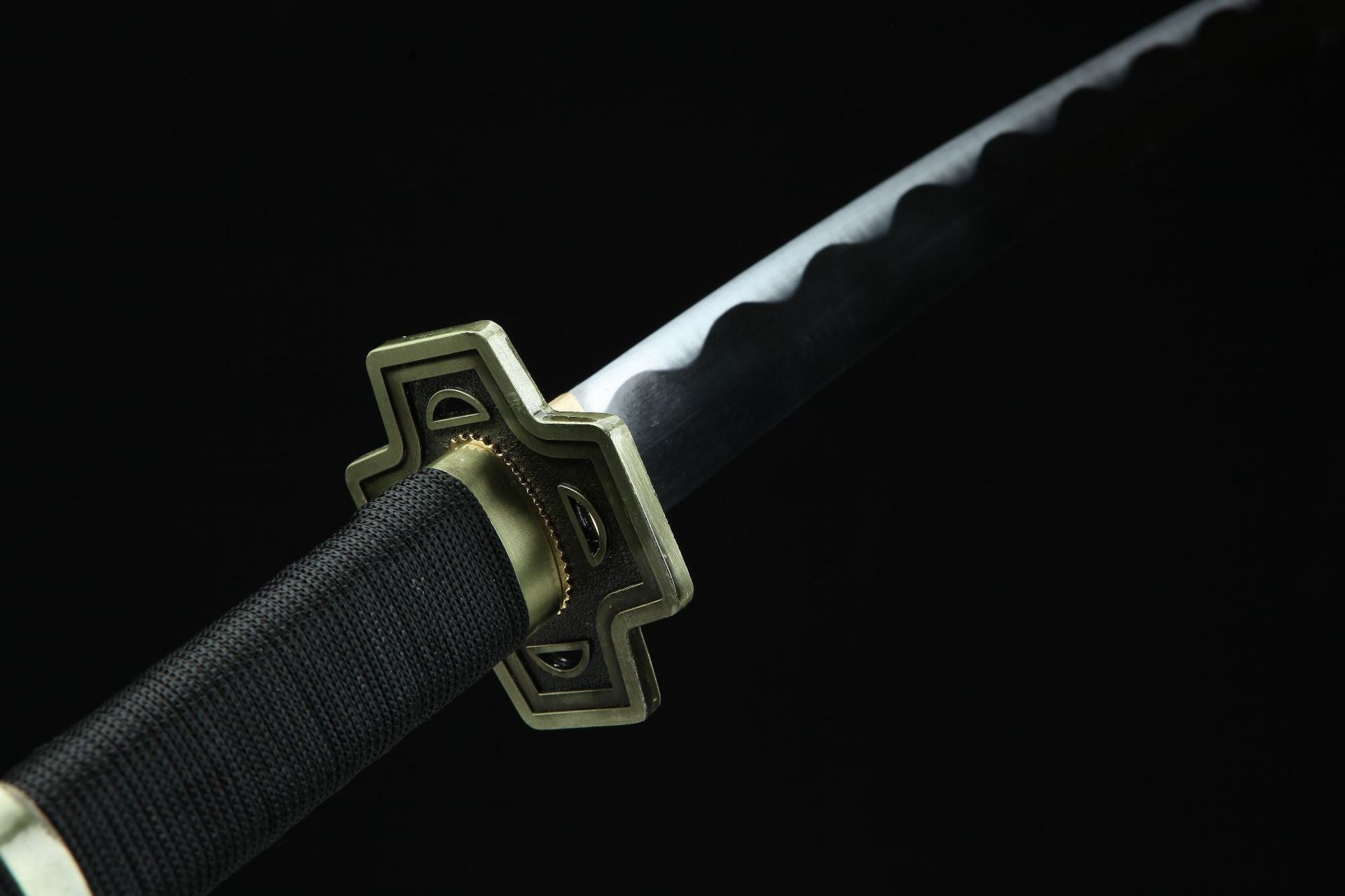 A detailed view of the black and gold Yubashiri sword guard.