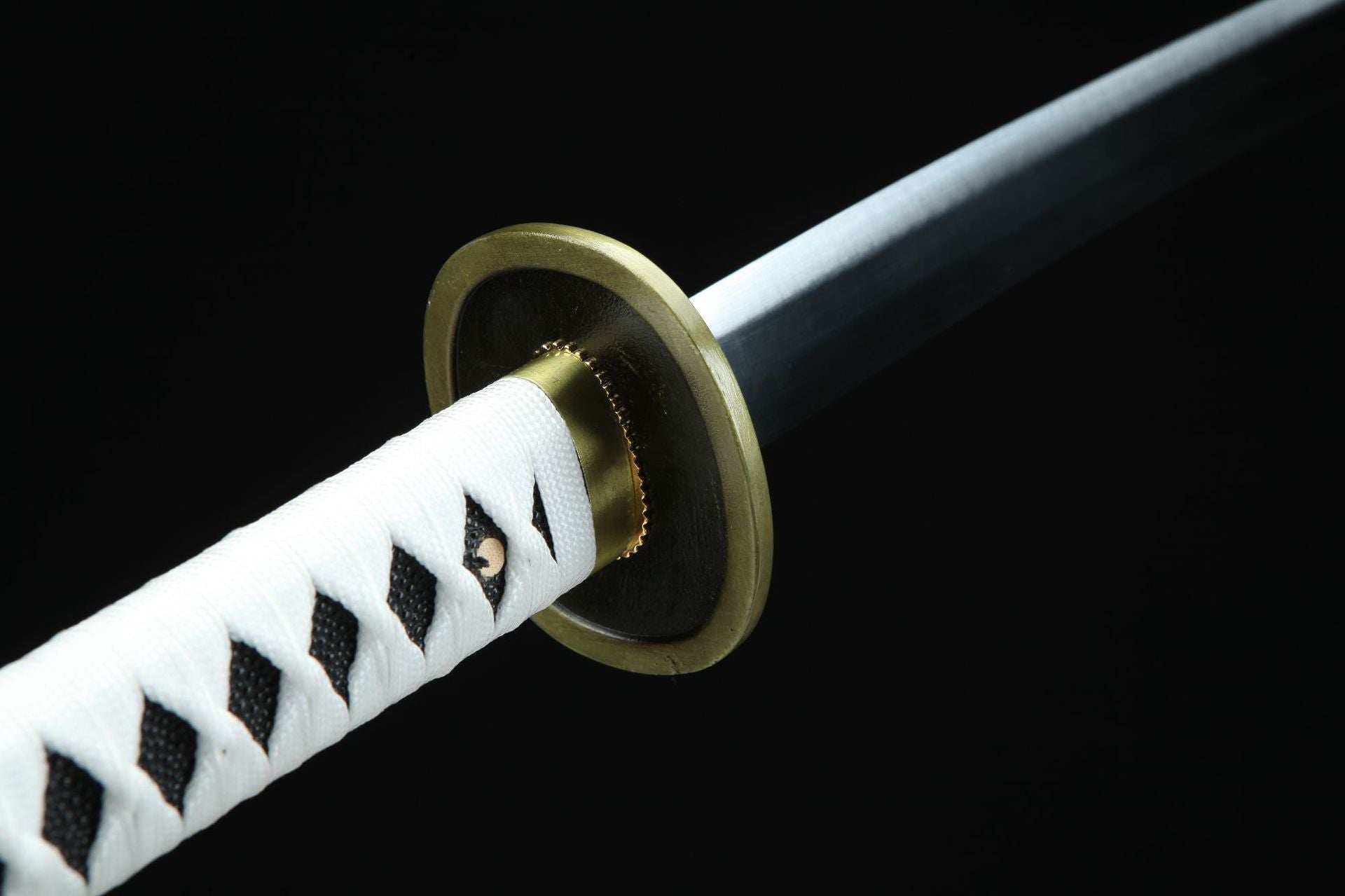 A detailed view of the white handle and round guard of the Wado Ichimonji sword.