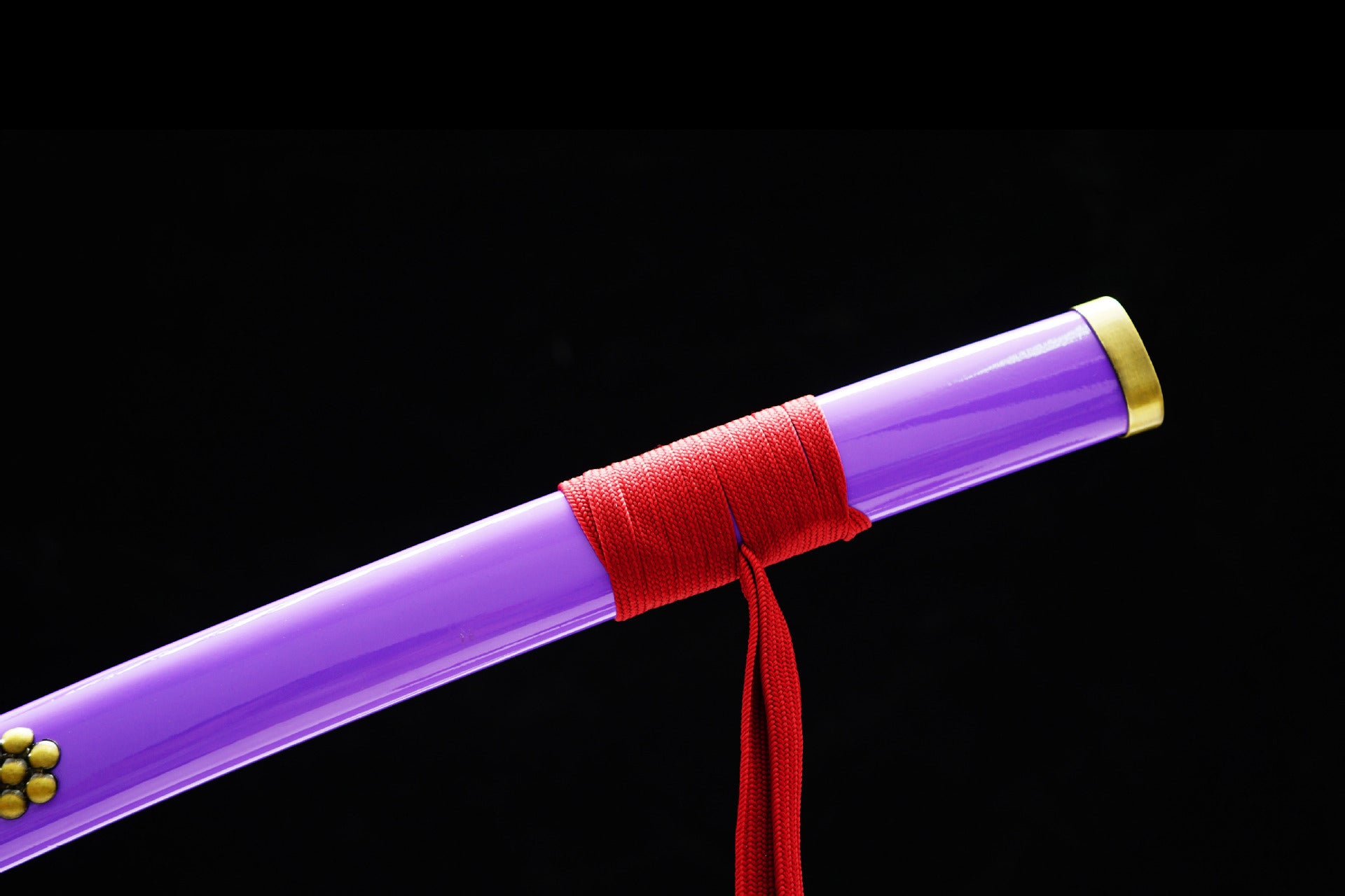 The Saya of Zoro's Enma sword from One Piece tied with a red Sageo.