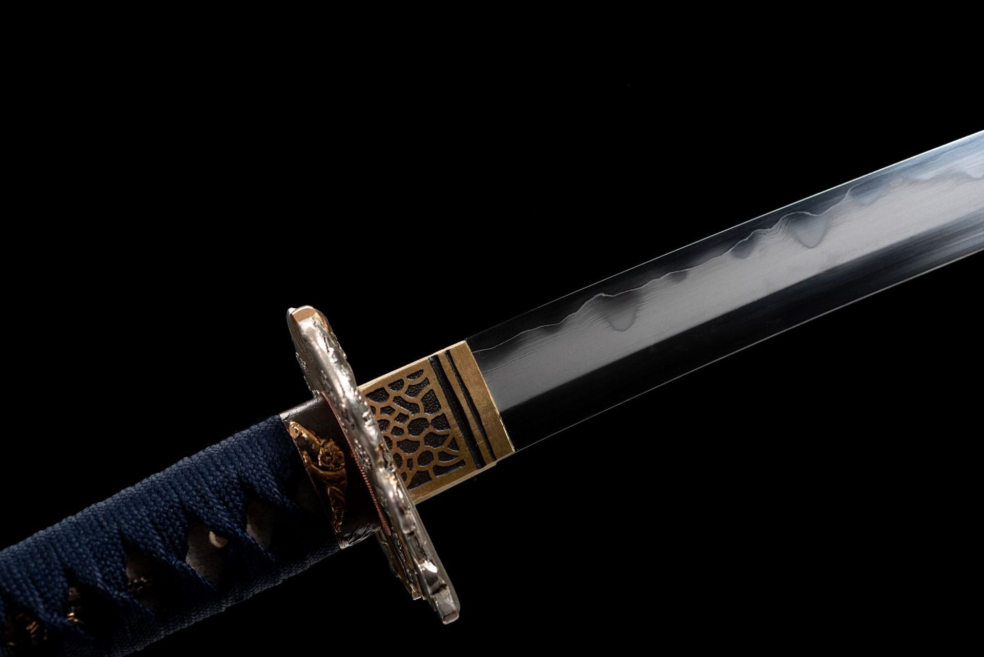 Close-up side view of the intricately designed tsuba on an Exorcism katana.