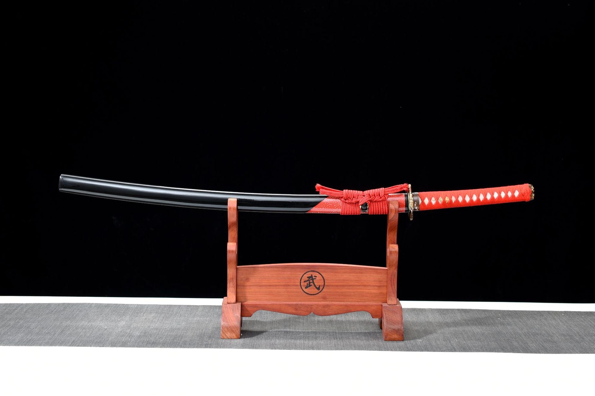 Fire Kirin katana mountings with red tsuka, sageo, and decorative tsuba.