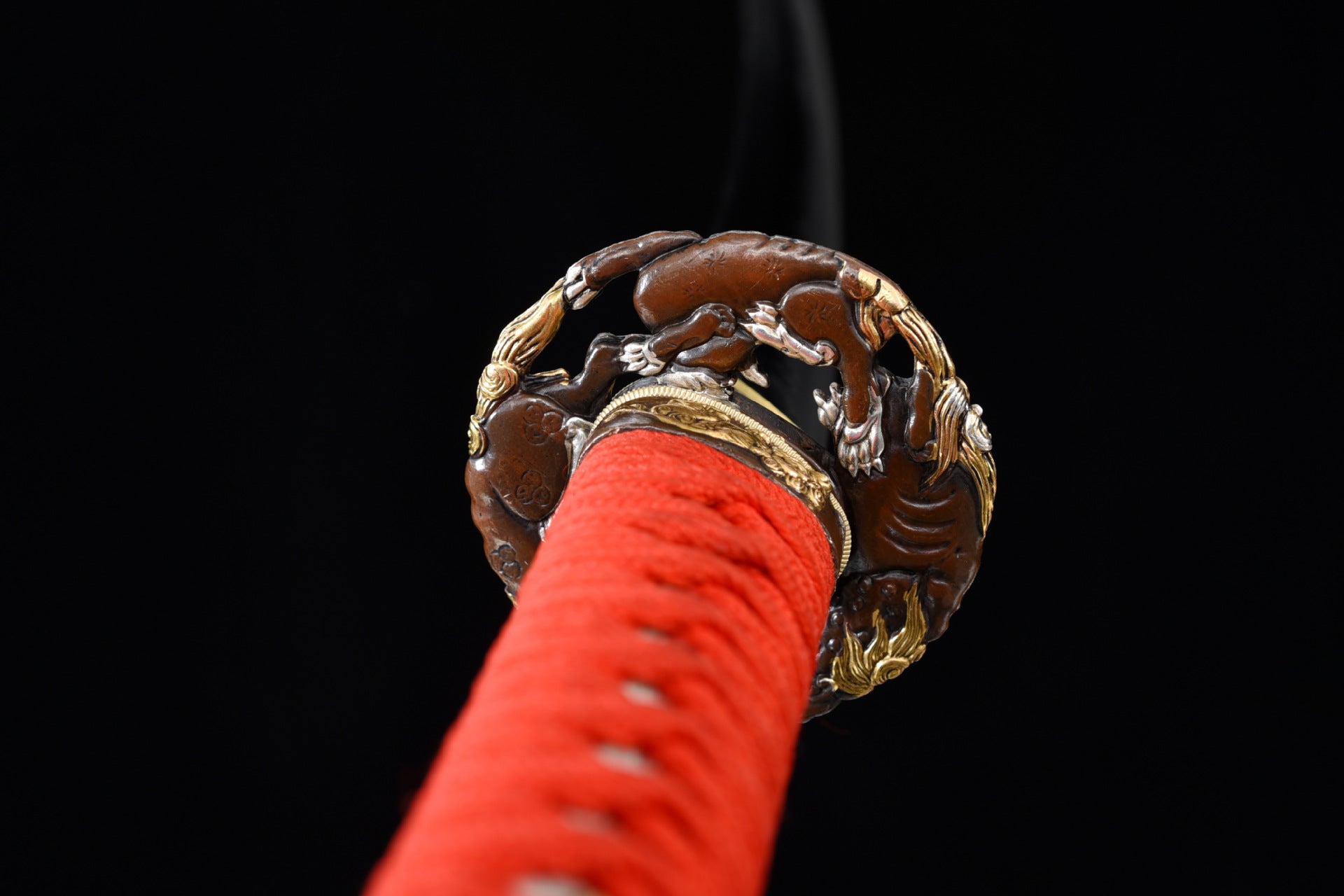 Decorative metal tsuba with a Fire Kirin motif.