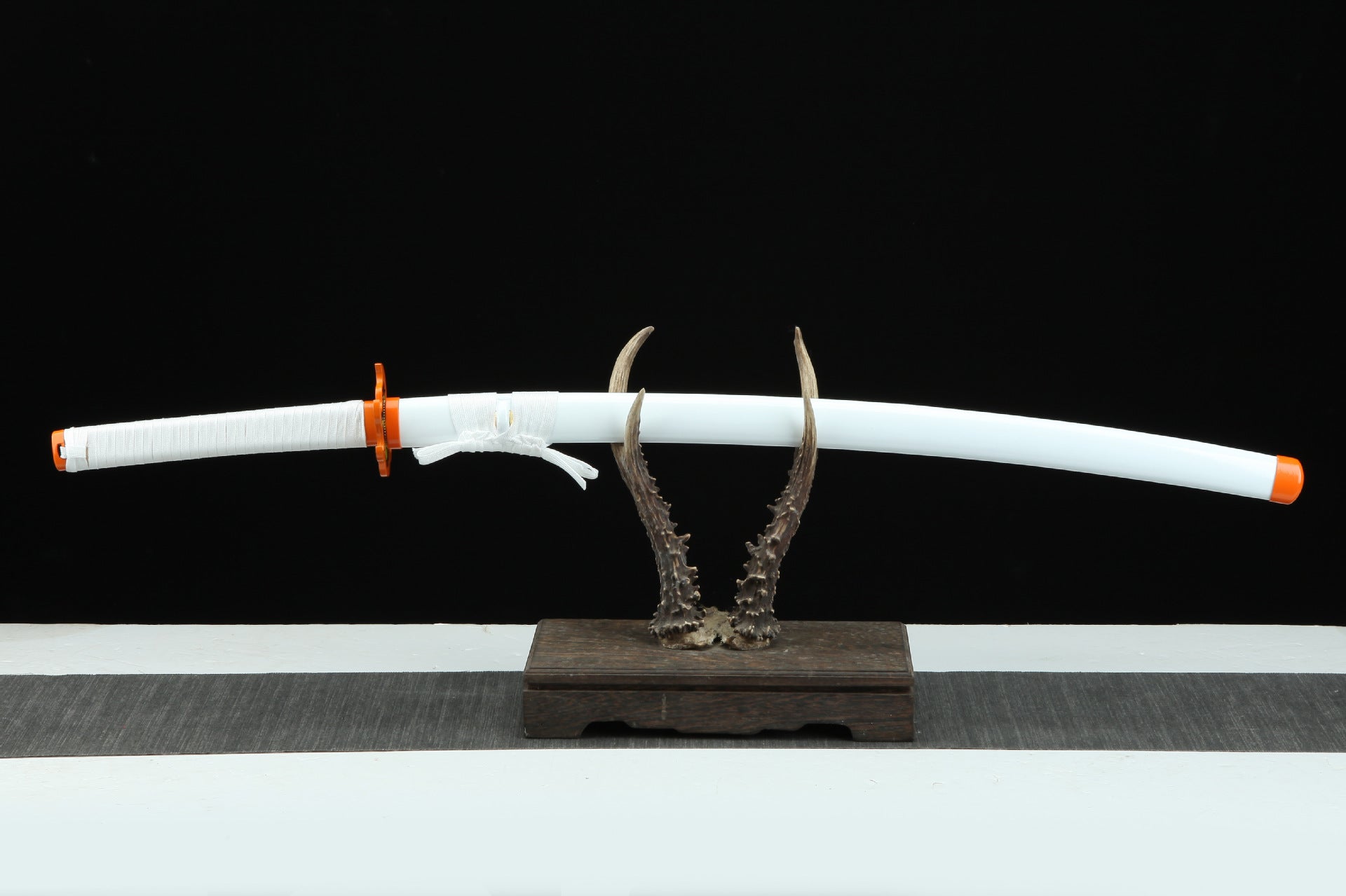 Flame Hashira Nichirin sword inserted in its white sheath.