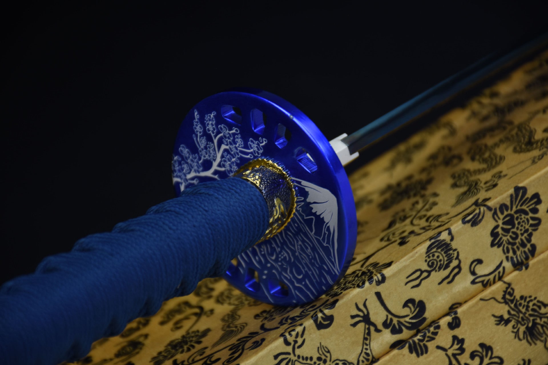 A katana tsuba featuring an intricate design of Mount Fuji and Sakura.