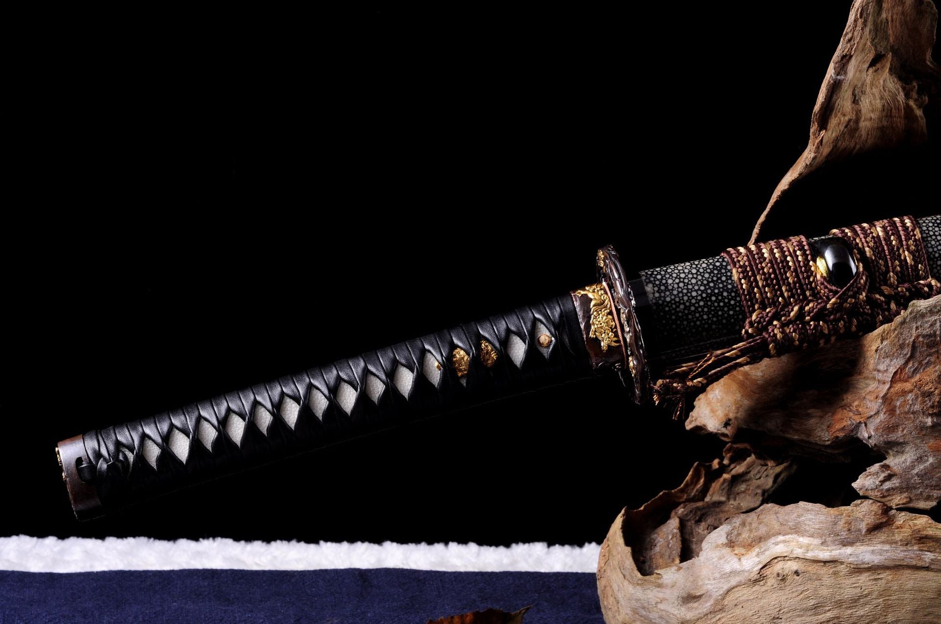 Genji katana handle with genuine ray skin and black leather wrap.