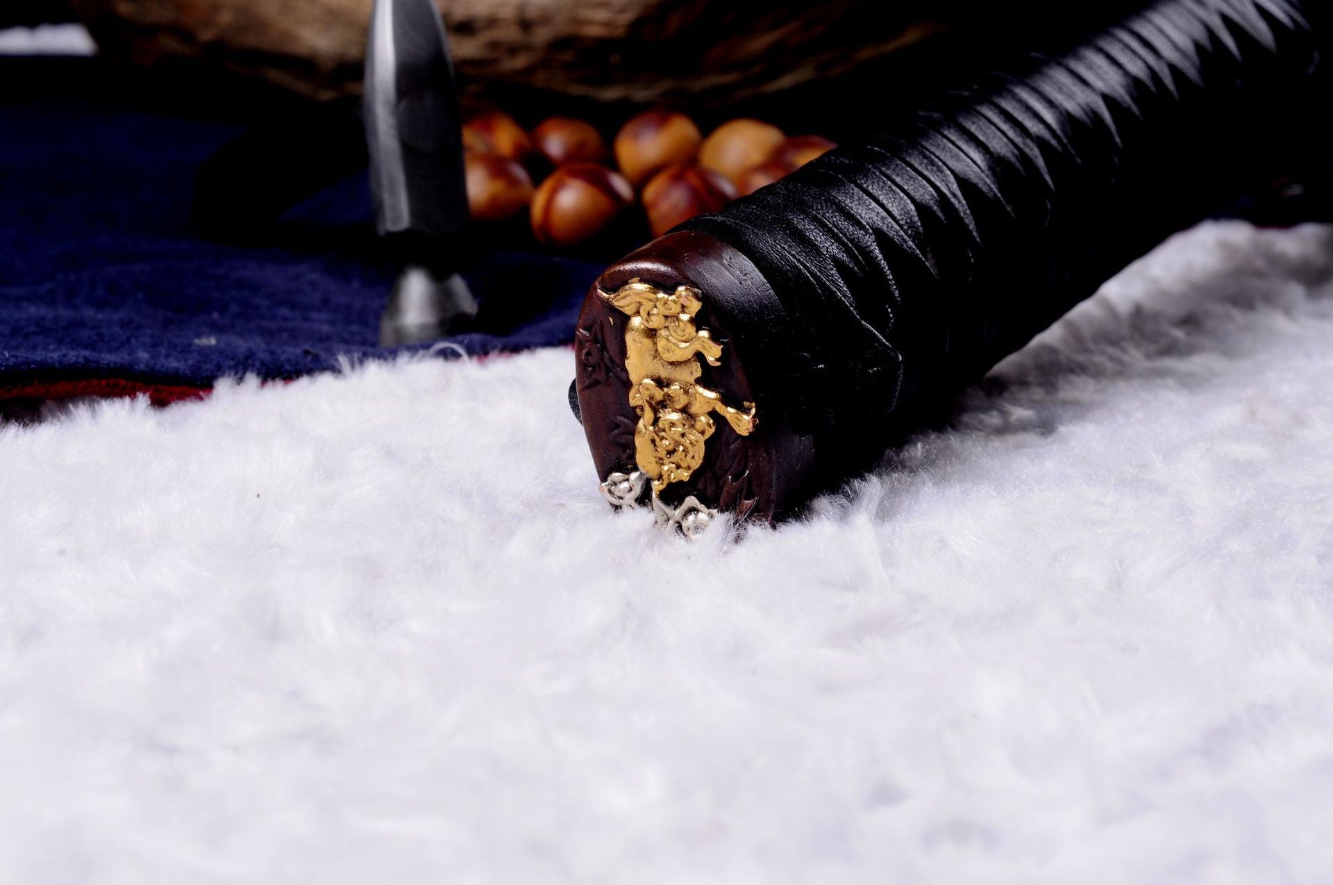 Engraved kashira on a Genji katana handle