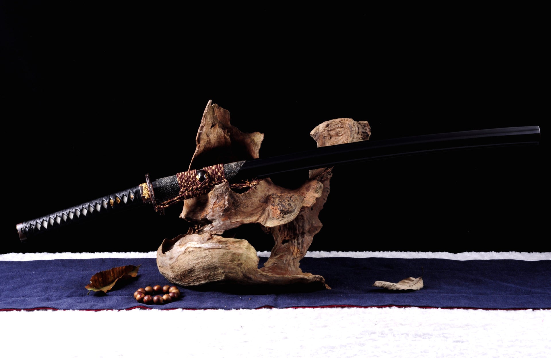 Dark-colored sword mountings on a Genji katana, ideal for collection and display.