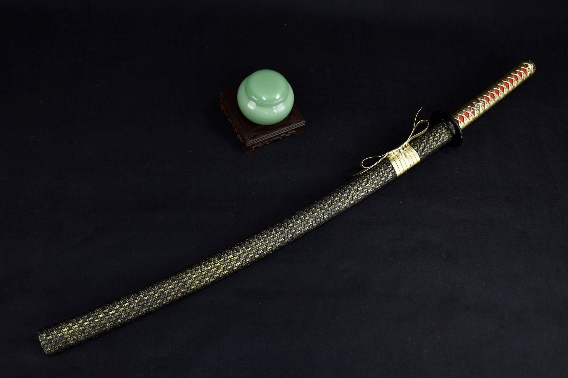 A katana with a gold and black design featuring elegant details