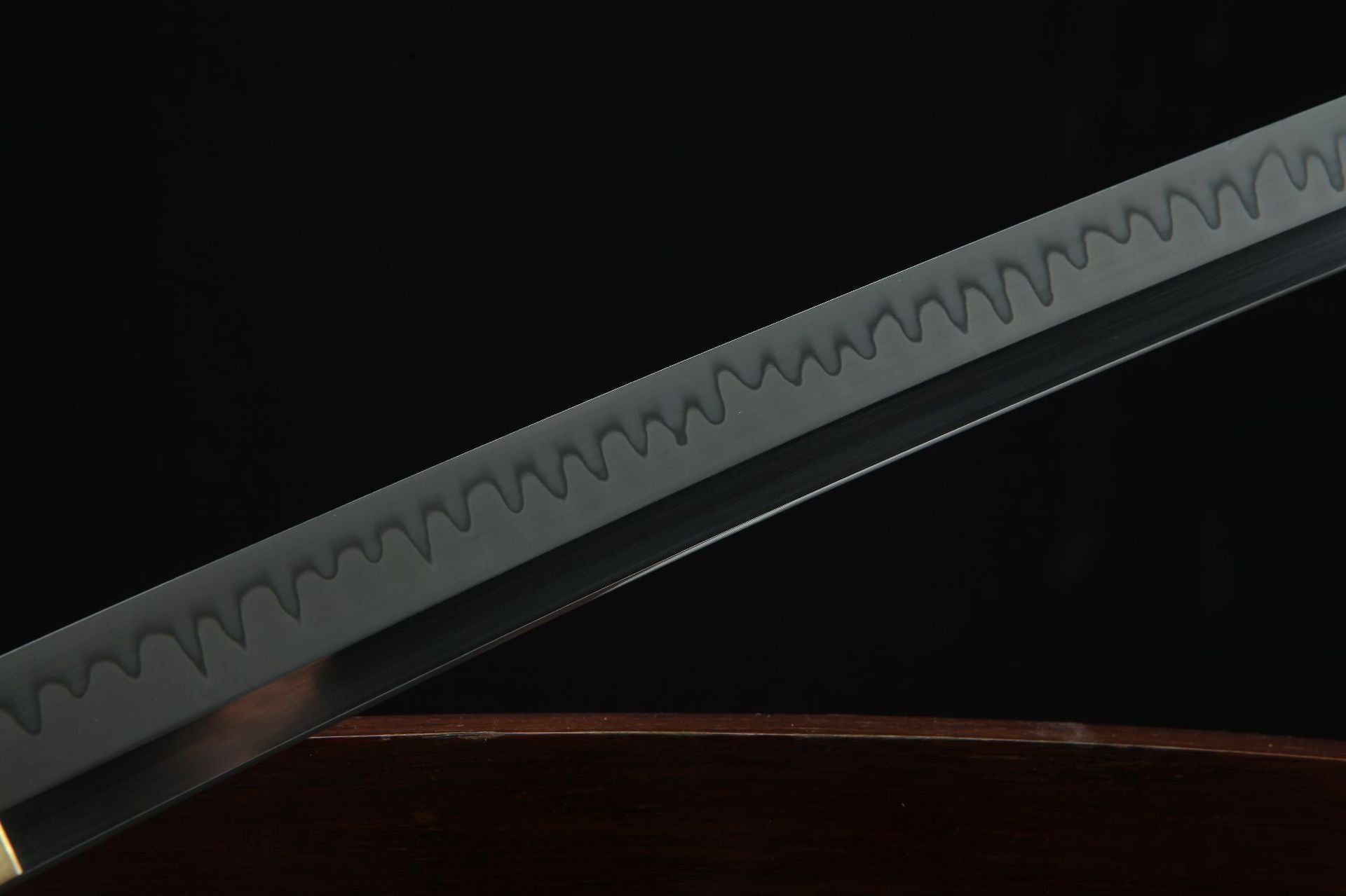 Close-up of the Golden Loong samurai sword's blade showcasing a wavy hamon pattern along its edge.