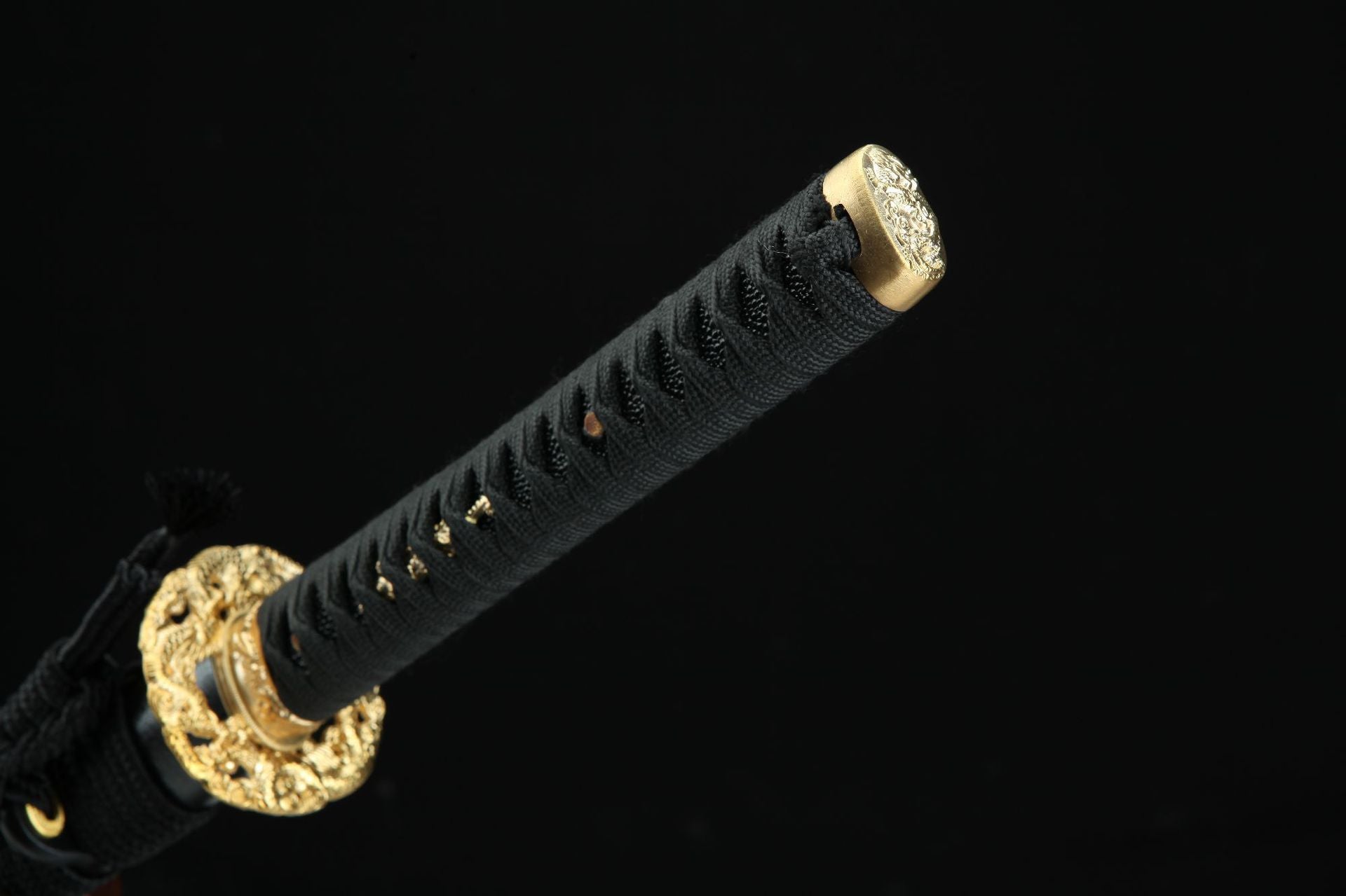 Close-up of the Golden Loong samurai sword's handle end with black wrapping and golden cap.