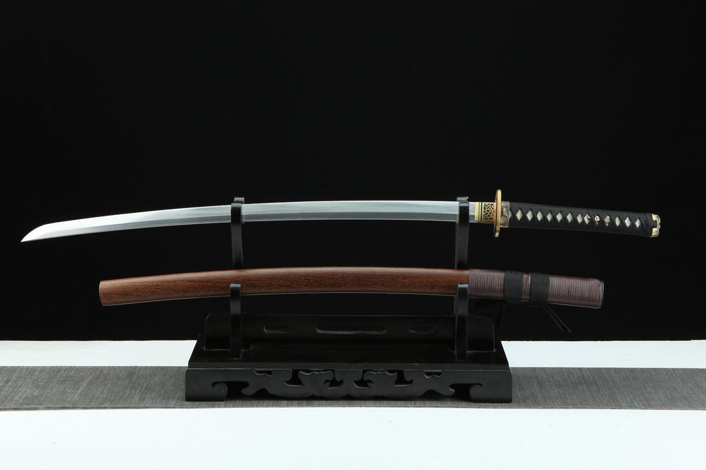 Jiang Tai Gong katana sword featuring a folded steel blade, black tsuka with white details, and a polished wooden saya displayed on a stand.