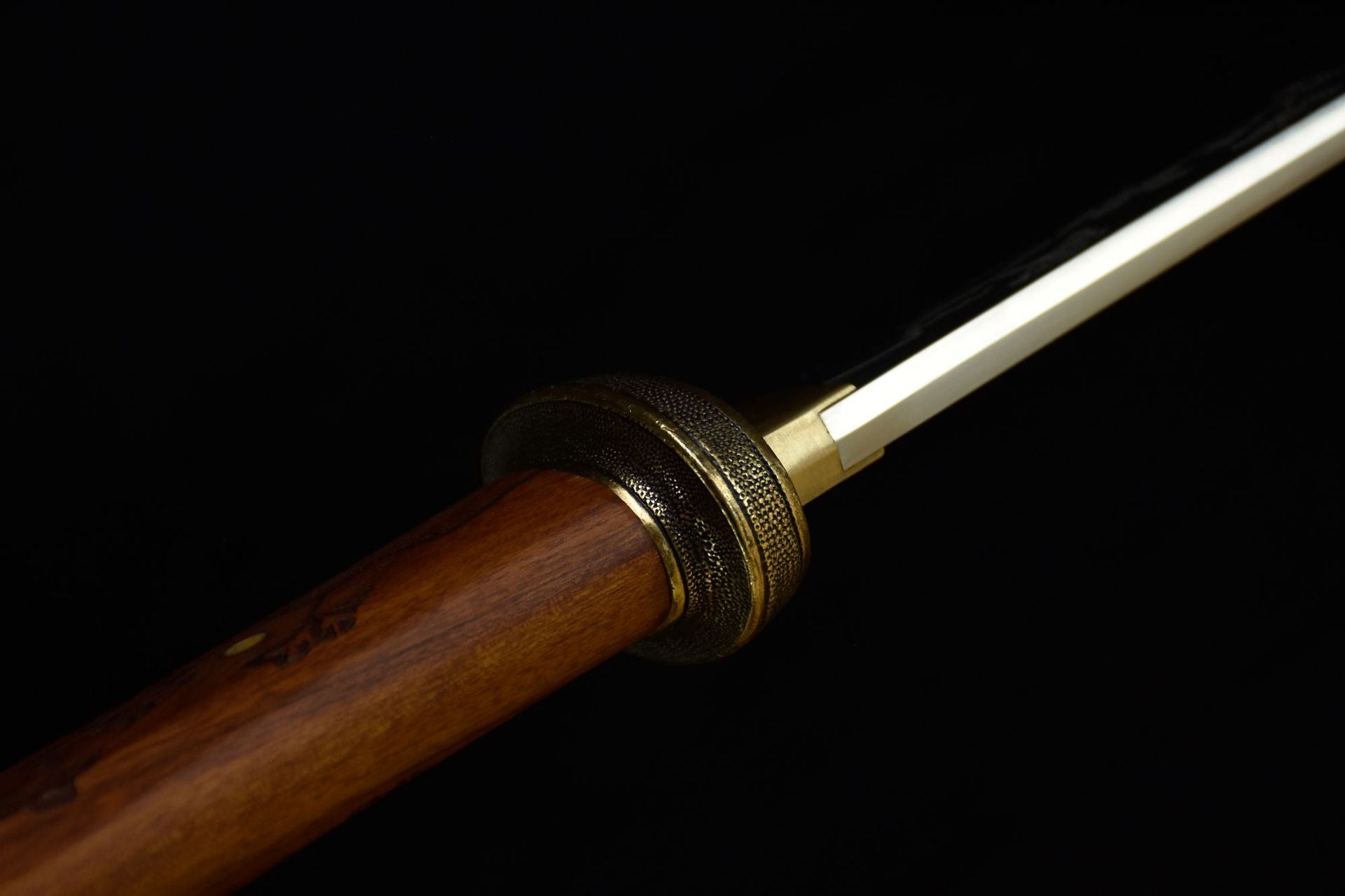 Close-up of the katana spine, highlighting the fine craftsmanship and detailing of the blade's back.