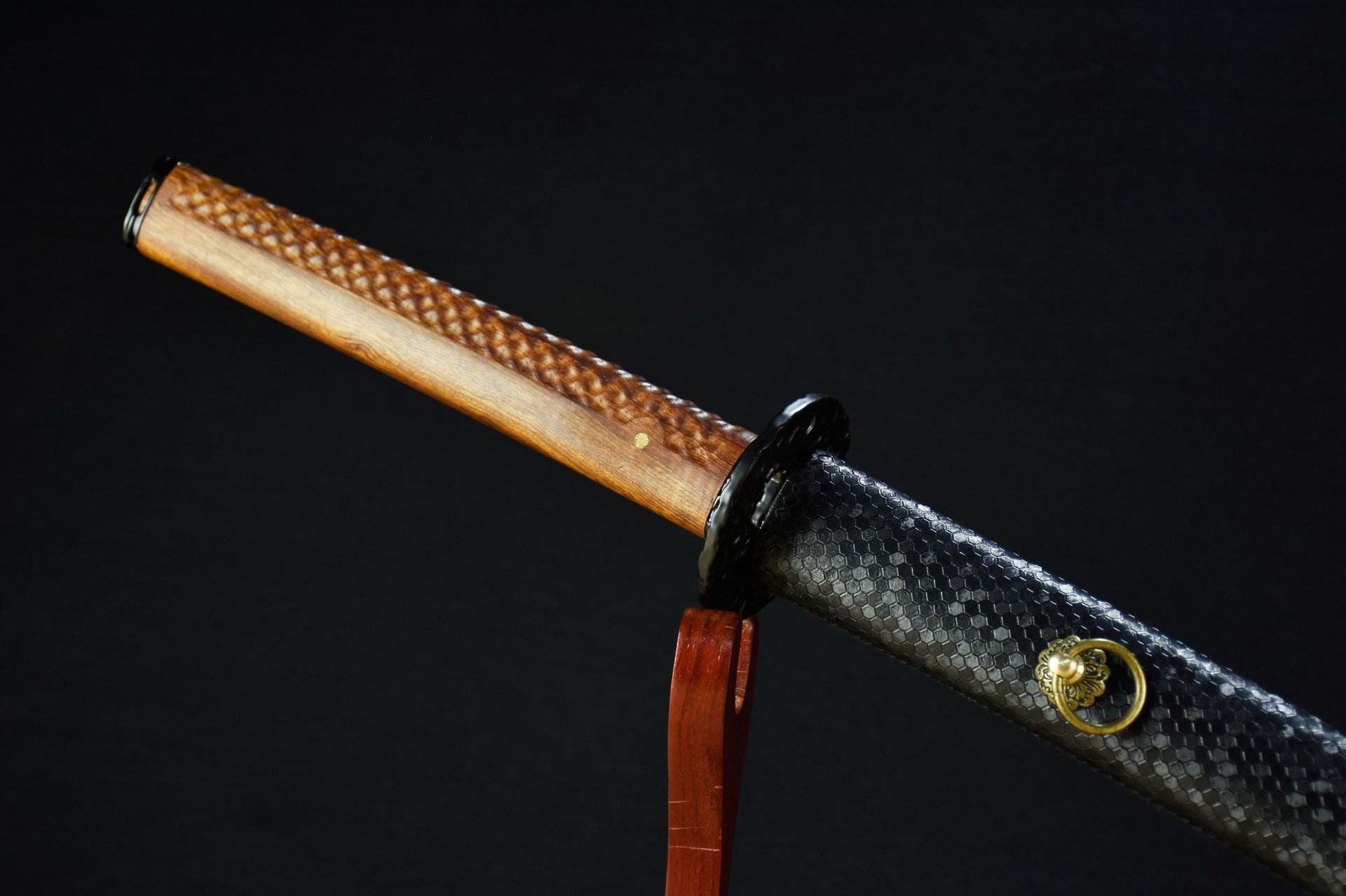A katana with a wooden handle, designed for a comfortable grip