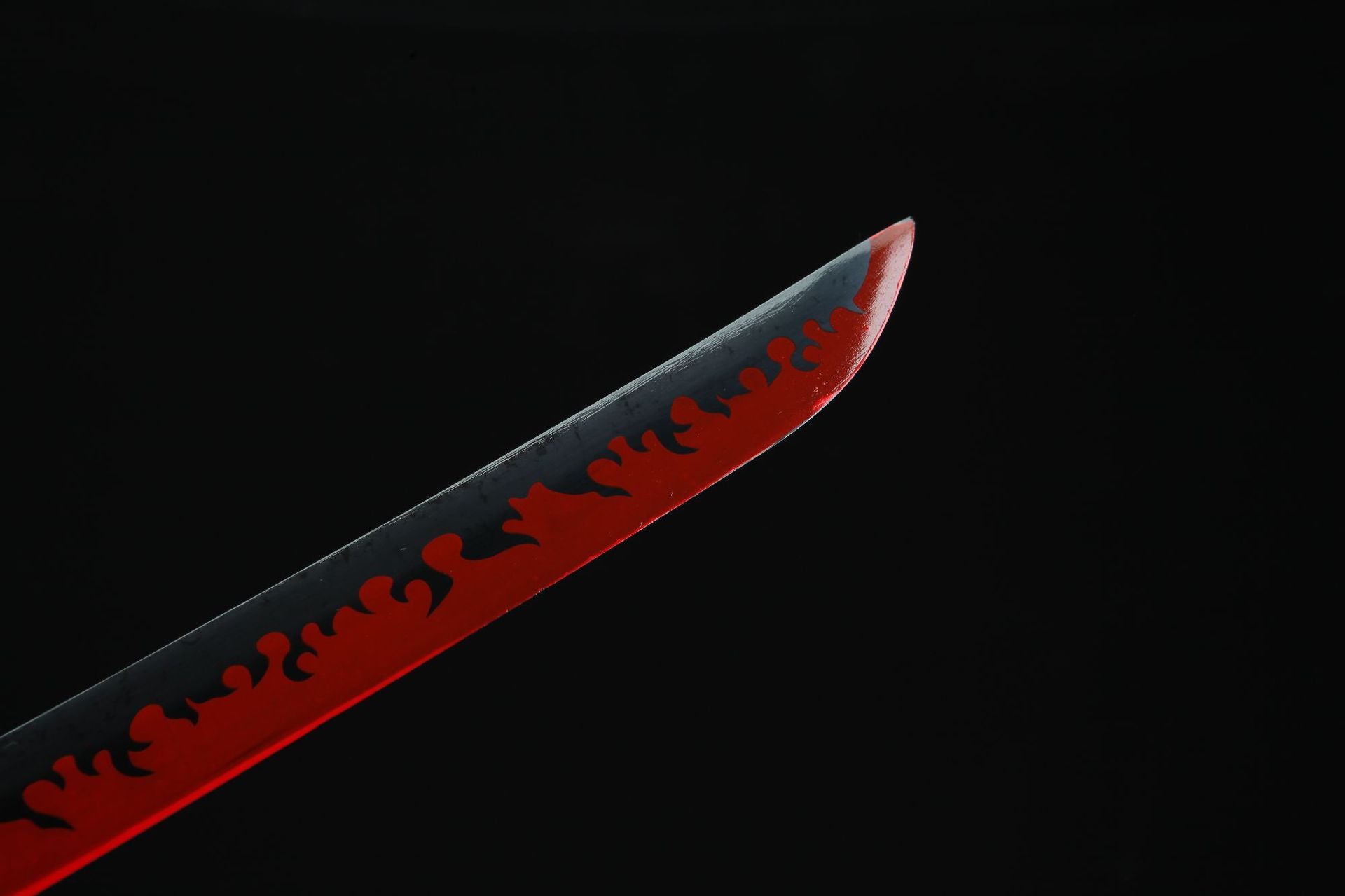 Kyojuro's Nichirin sword with red flame-like blade close-up.