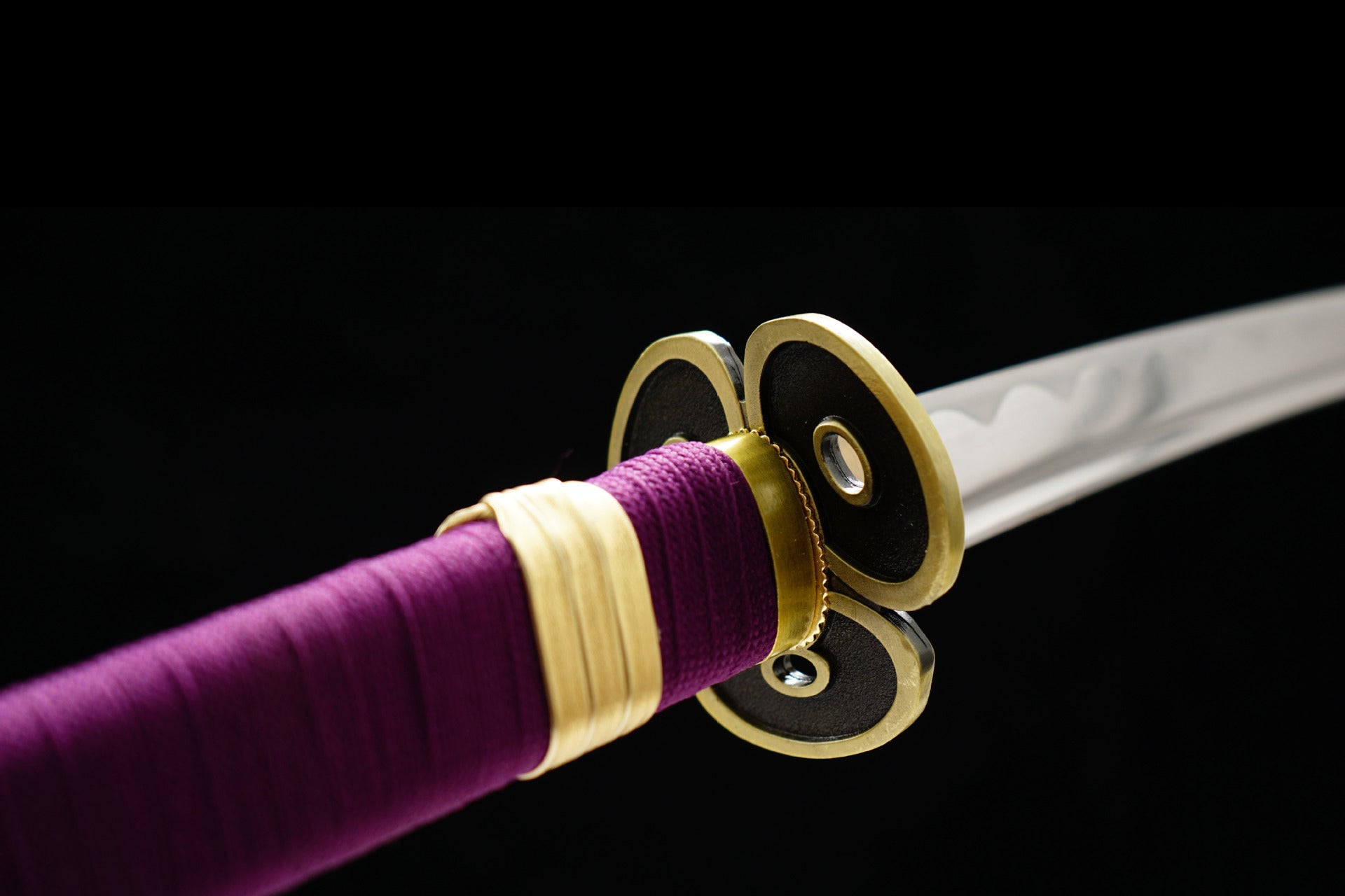 The three-leaf-shaped Tsuba of the Enma sword from One Piece with a hole in each leaf.