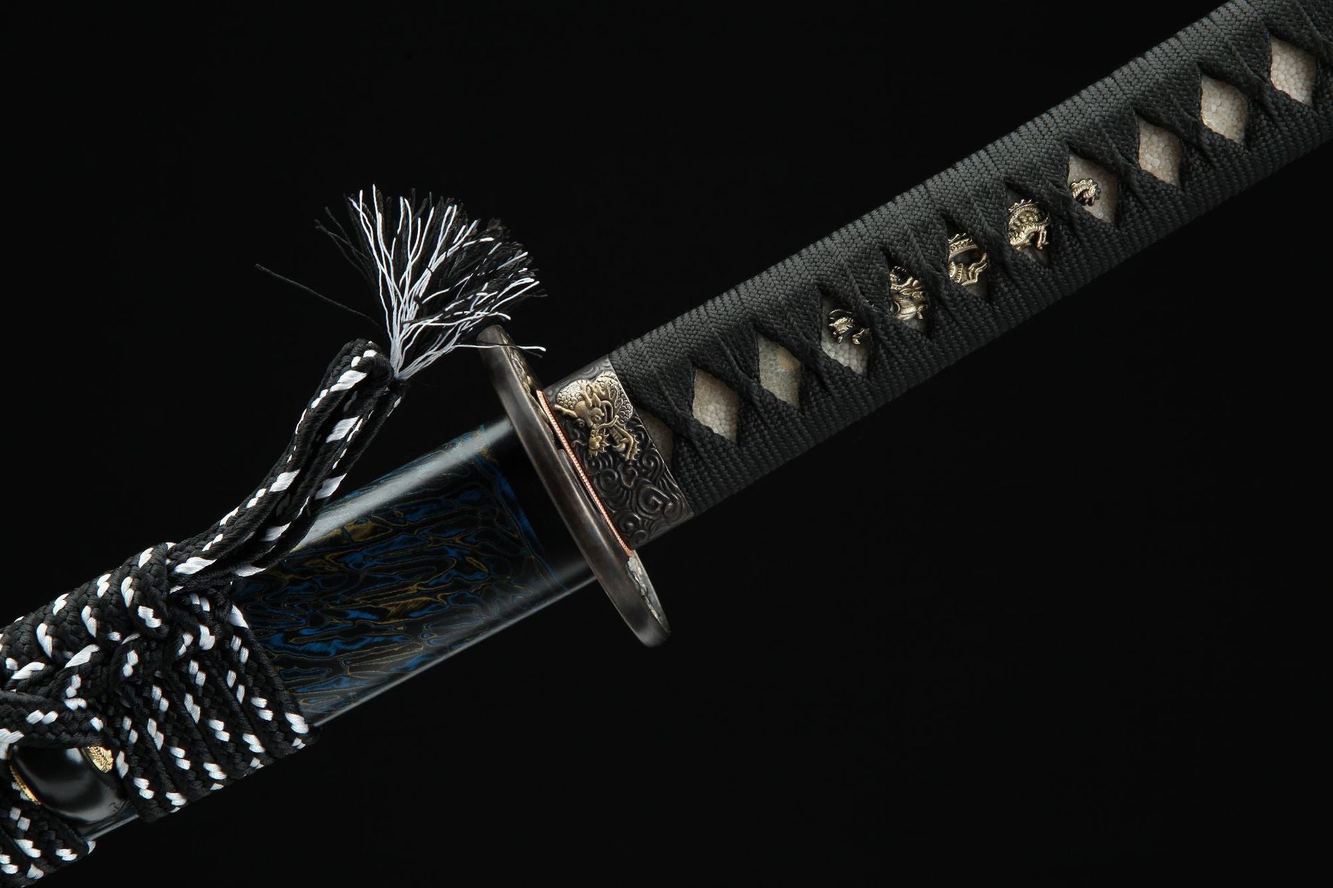Close-up of Seiryu Samurai sword handle with black cord wrapping and tsuba details.

