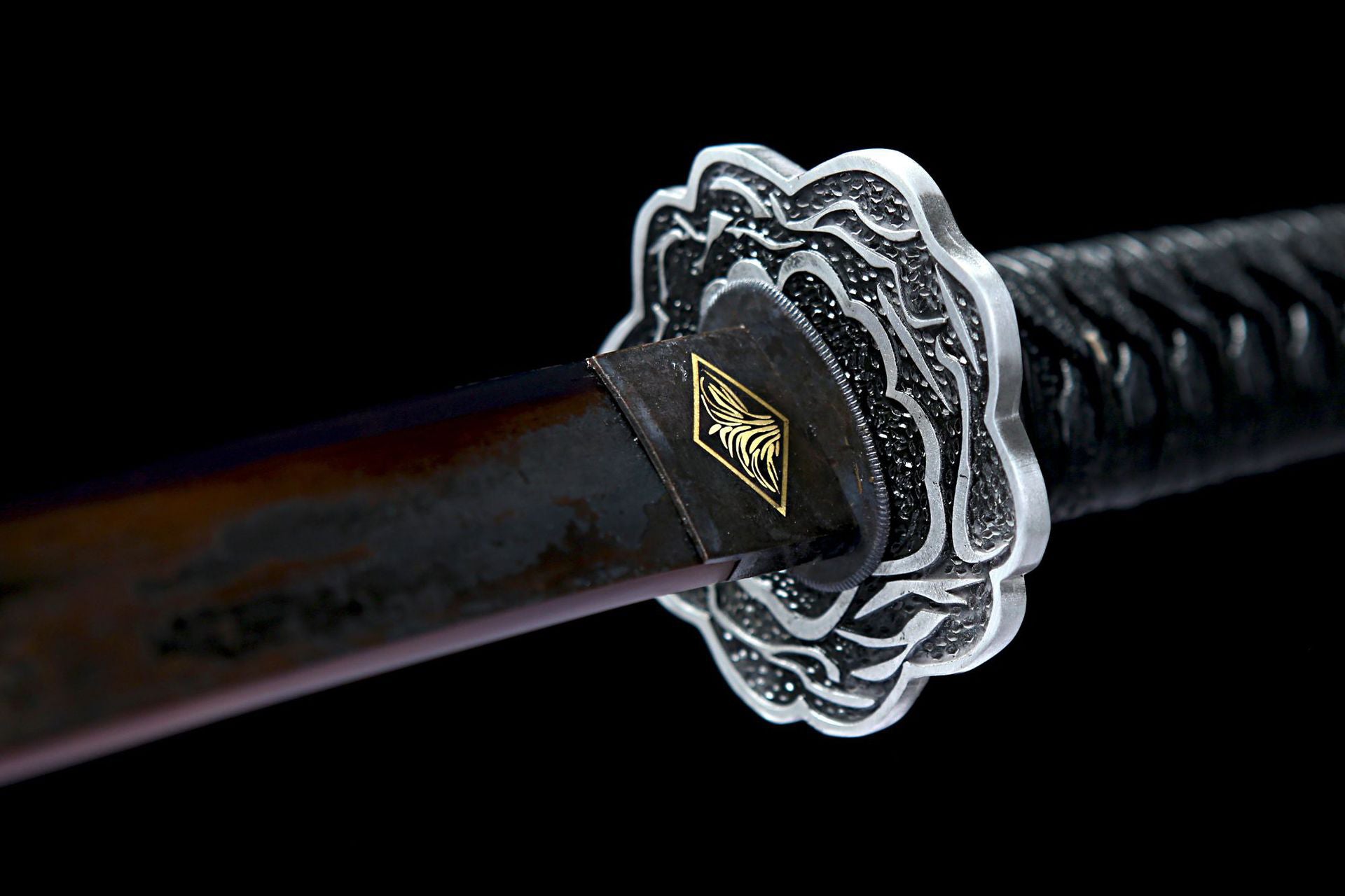 Close-up of the Sekiro Mortal Blade Samurai Sword guard with intricate floral design.