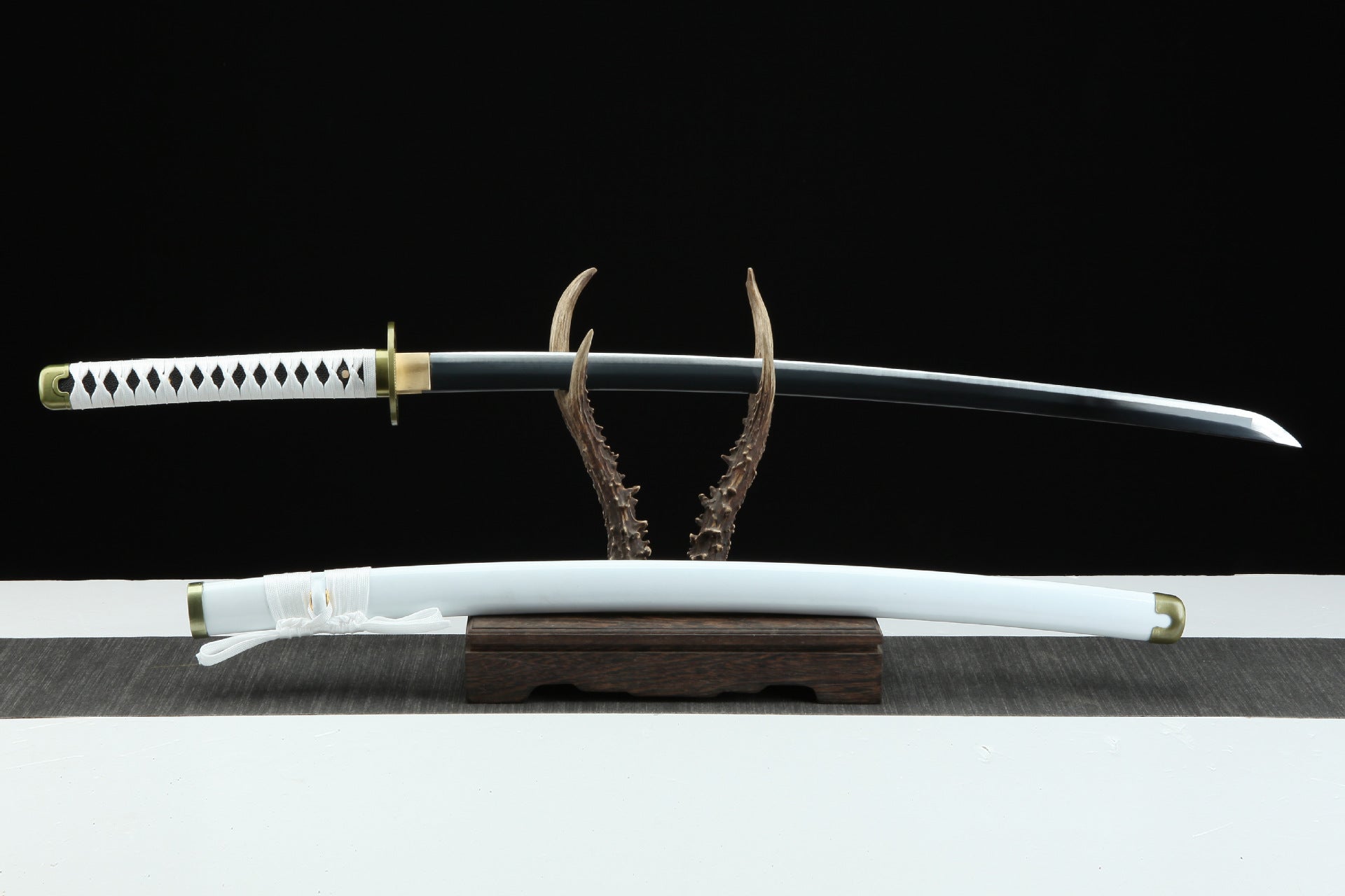 The Wado Ichimonji sword of Zoro displayed on a stand, showcasing the entire sword and sheath.