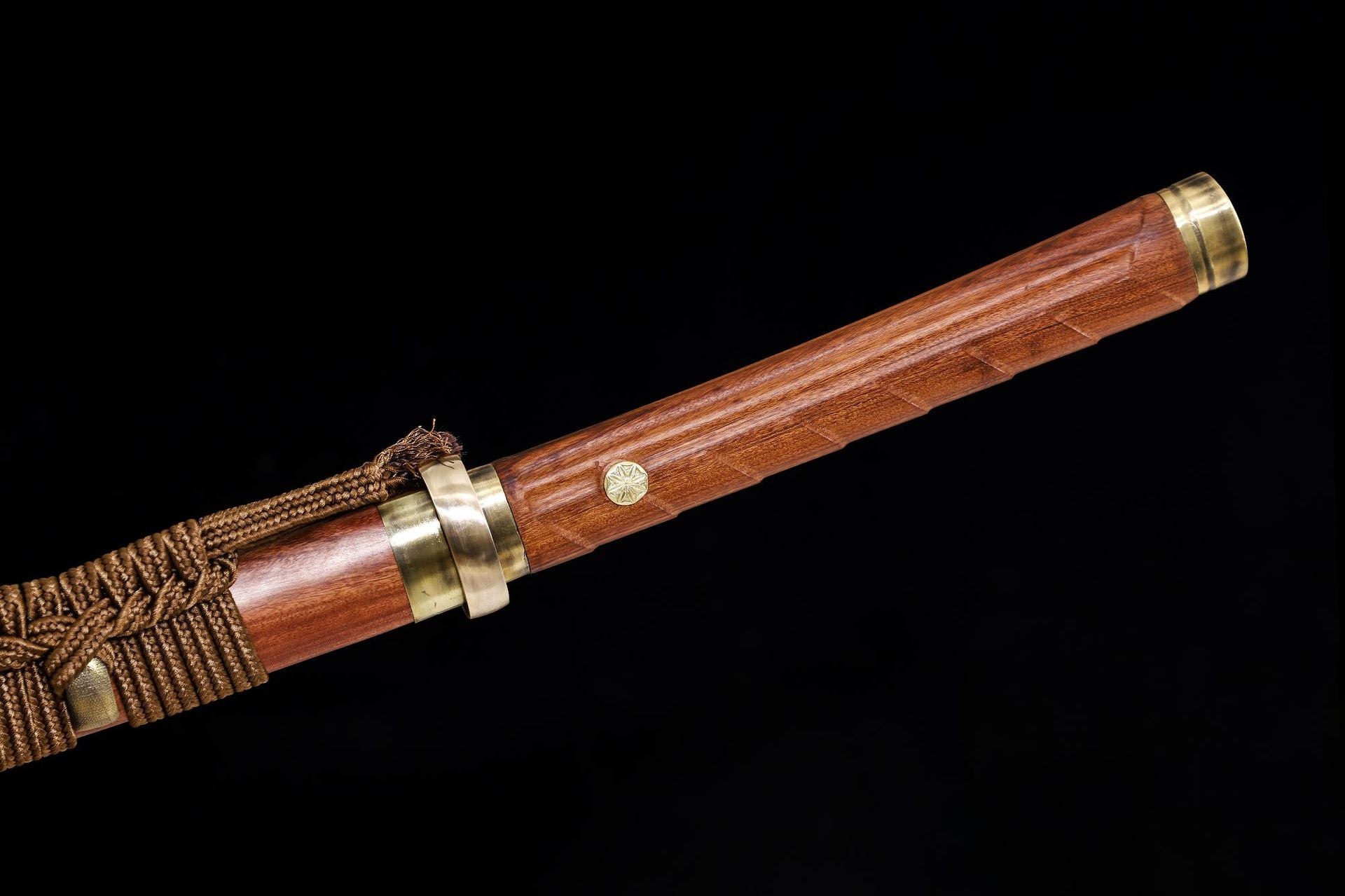  Close-up of the samurai sword handle with brass fittings and sageo cord wrapping.