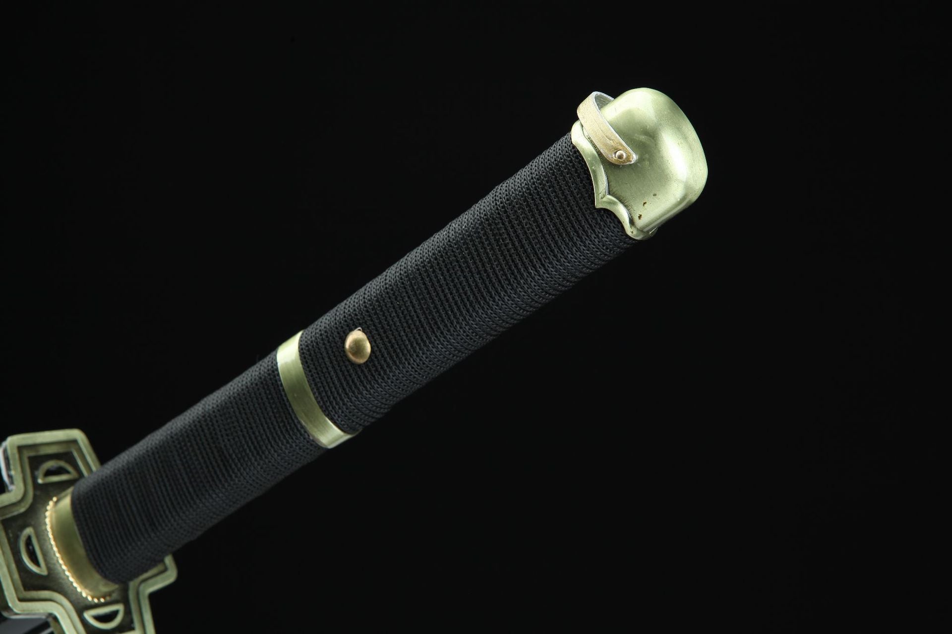 A black Yubashiri sword handle, complemented by brass fittings.