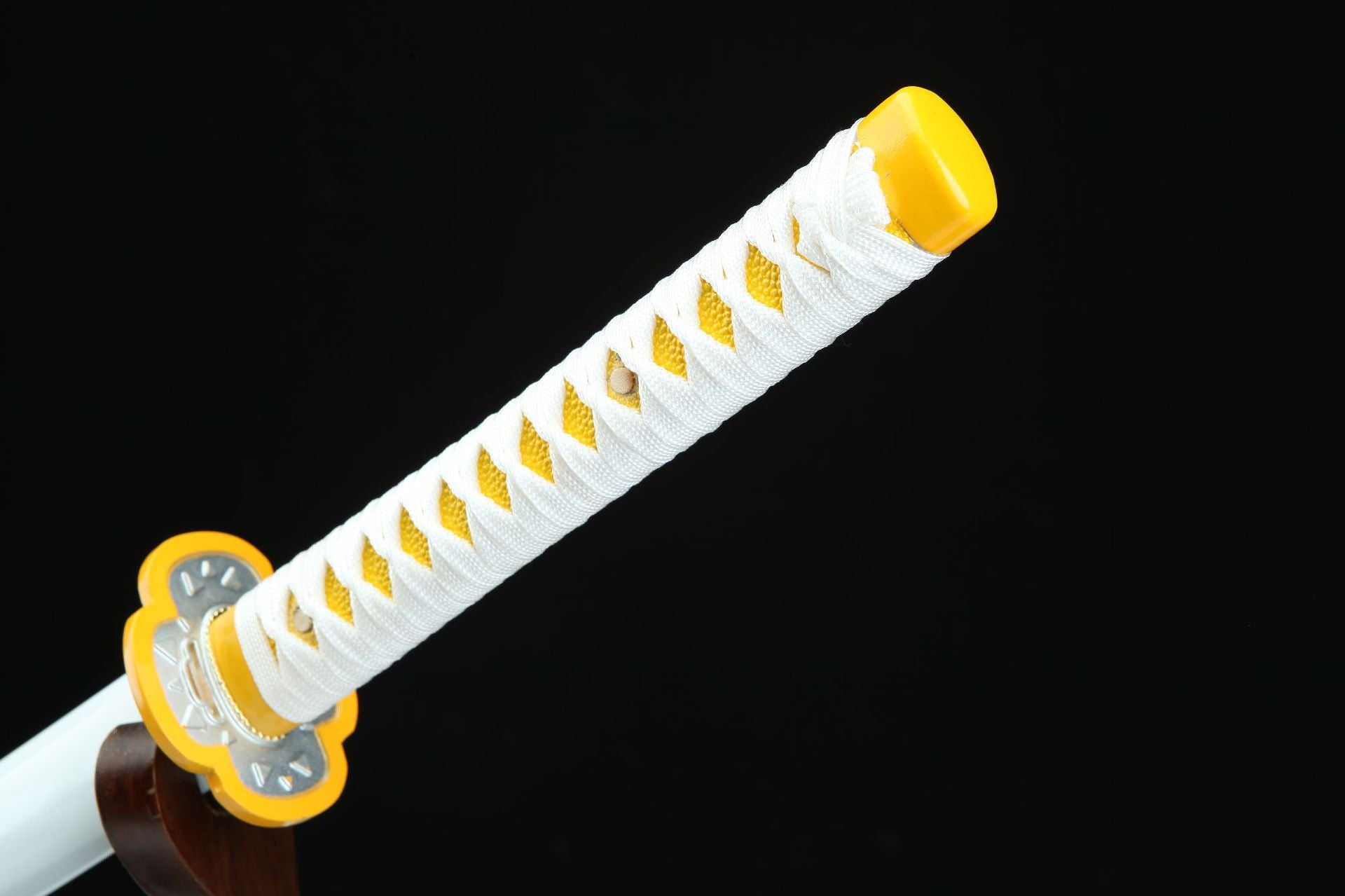 Zenitsu's sword featuring a yellow handle wrapped in a white ribbon.