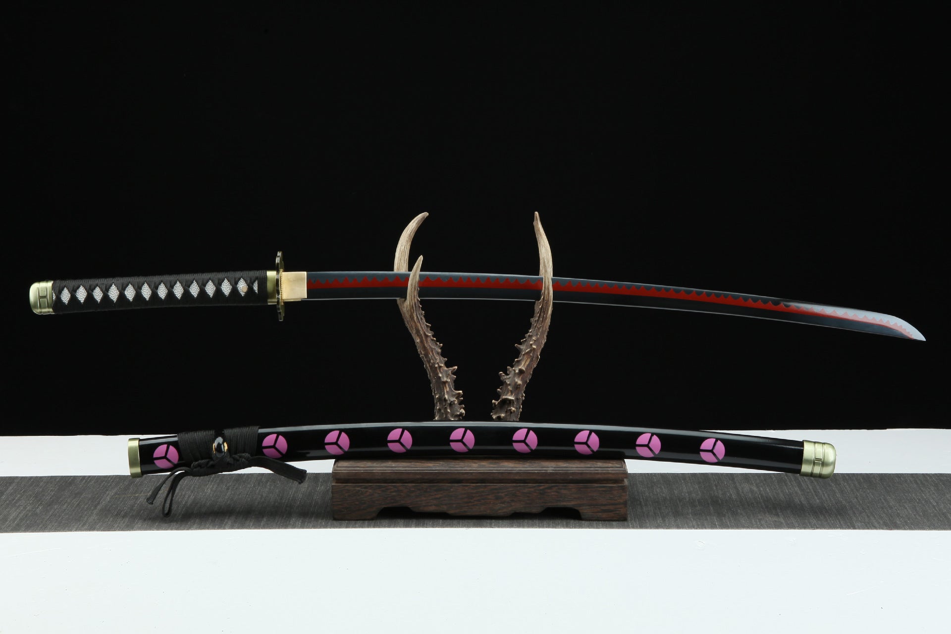 Zoro's Shusui sword and scabbard from One Piece anime displayed on a stand.