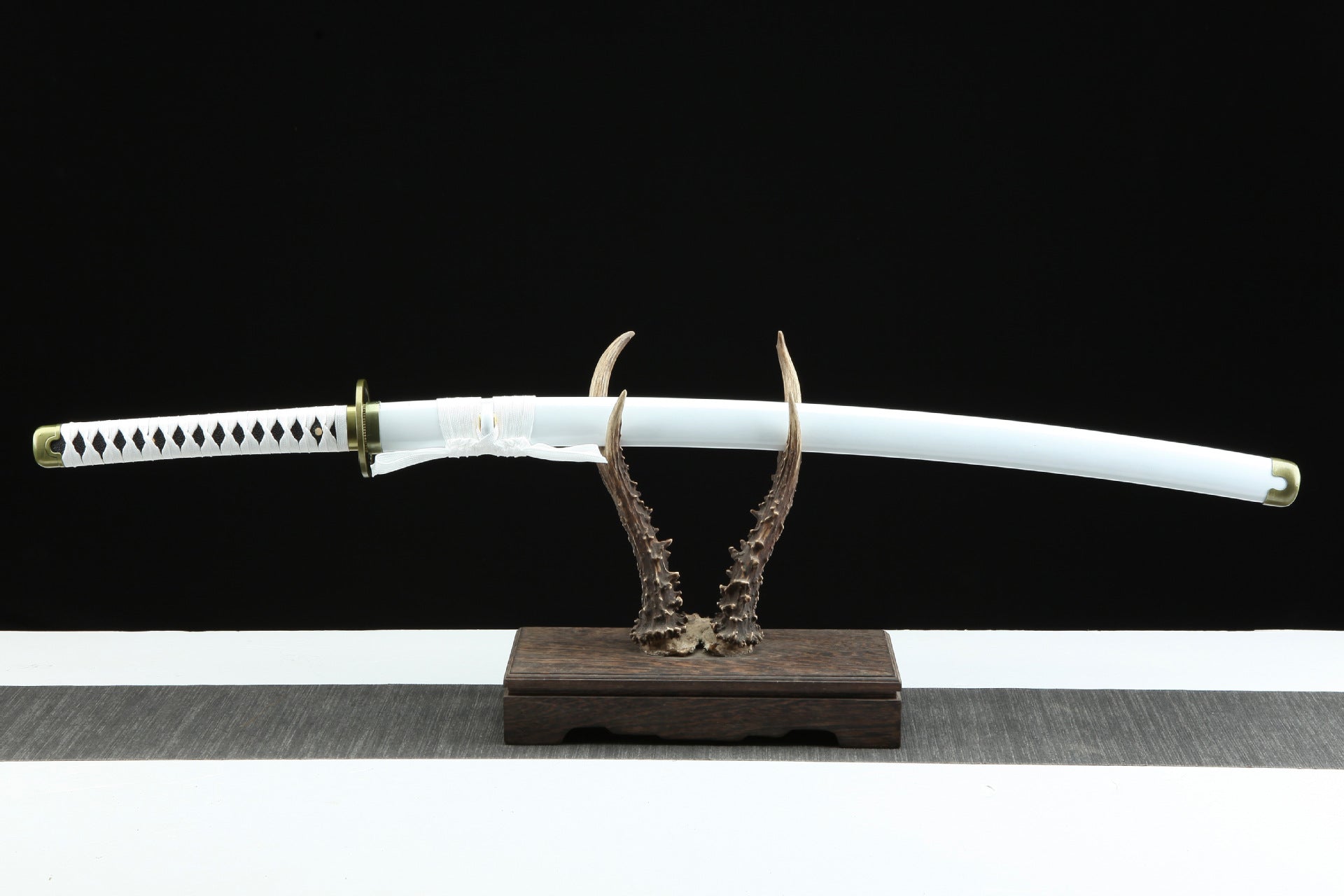Wado Ichimonji sword sheathed in its scabbard and displayed on a stand.