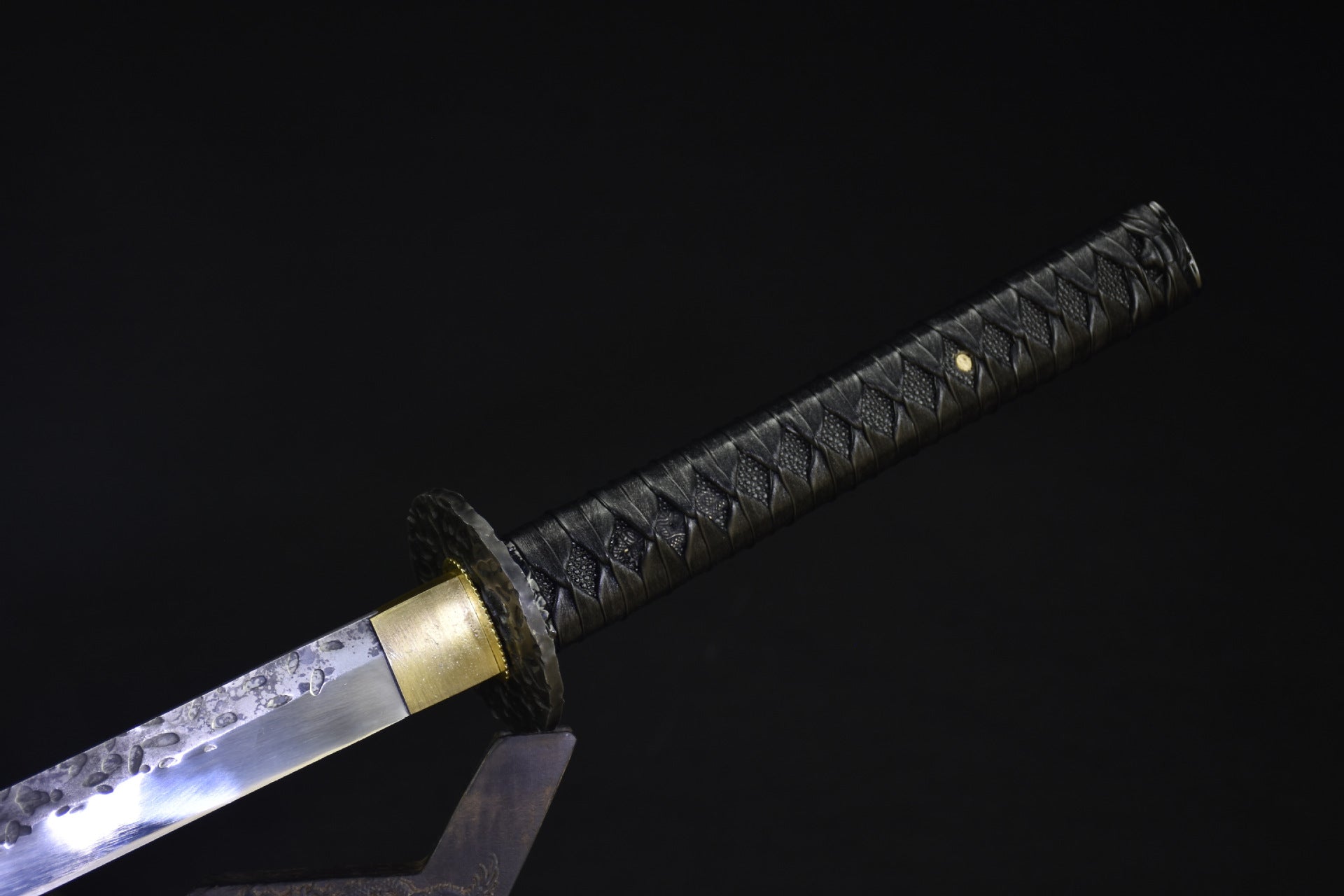 A black tsuka, the handle of a samurai sword.