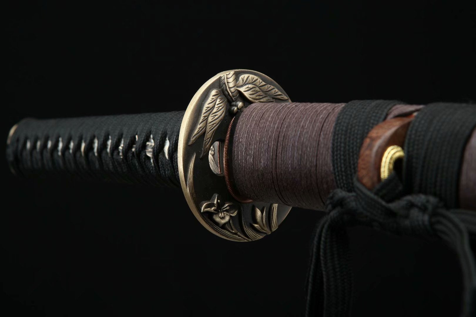 Brass tsuba of the Dragonfly Wakizashi with a dragonfly engraving, a symbol of strength and agility in Japanese culture.