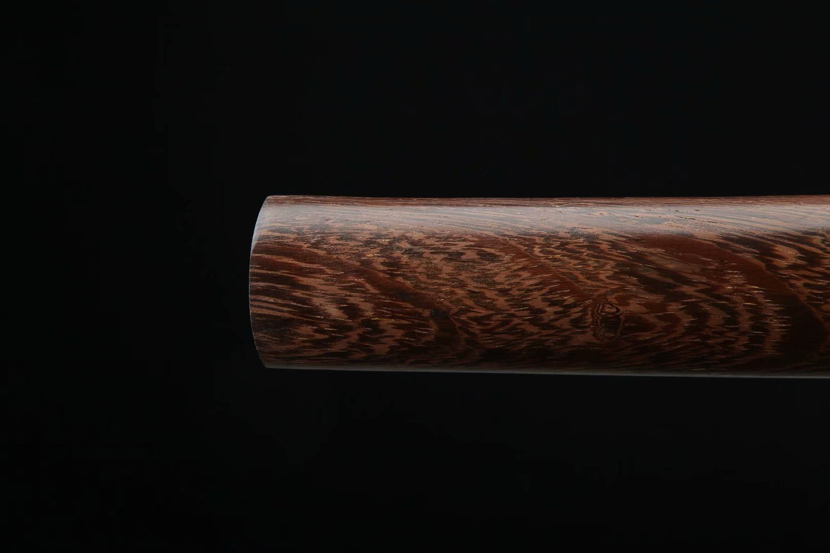 Detailed view of the Dragonfly Wakizashi scabbard made of polished wood with natural grain texture.