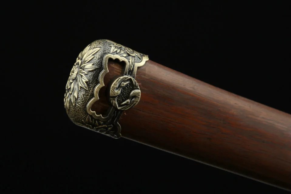A finely crafted kojiri on a katana scabbard, showcasing intricate detailing and traditional Japanese craftsmanship.