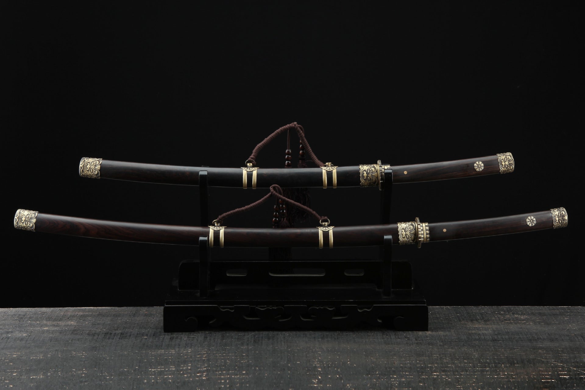 Lion katana and wakizashi in matching wooden scabbards with ornate copper fittings