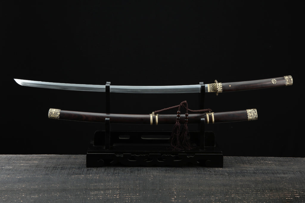 Full view of the Lion samurai sword with ornate copper fittings and a polished wooden scabbard