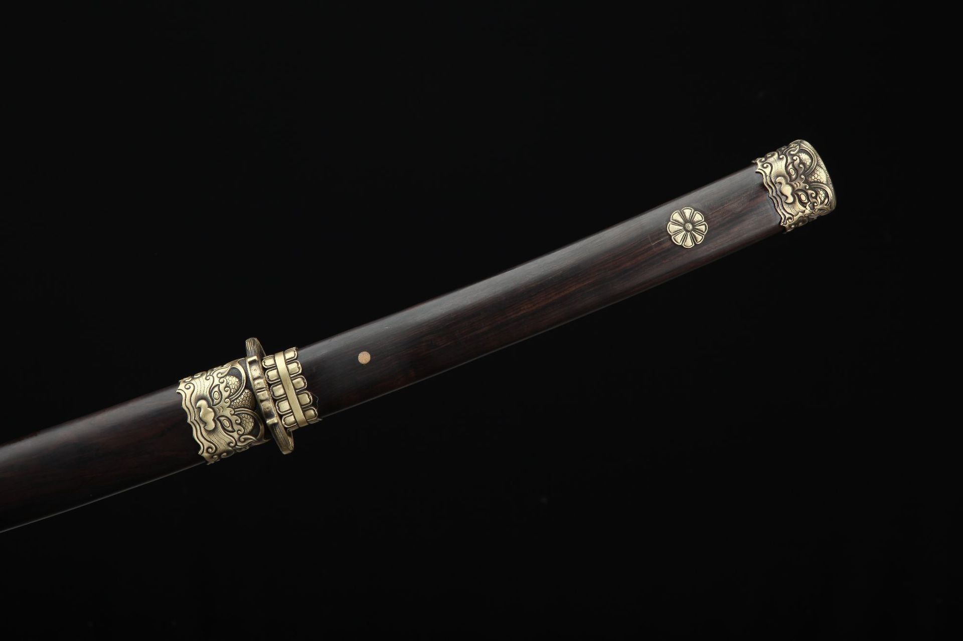Close up of the Lion samurai sword ebony handle featuring copper fittings