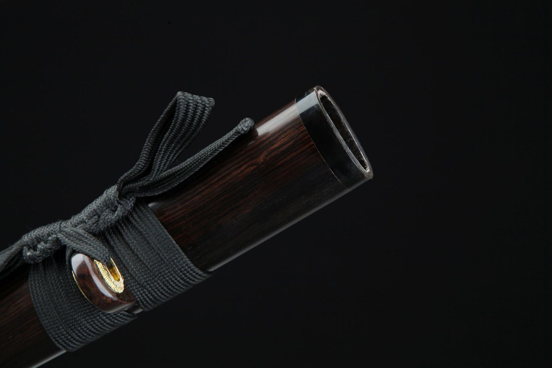 The gashira of a Loong katana features an intricate carving of a mythological battle scene with a loong.
