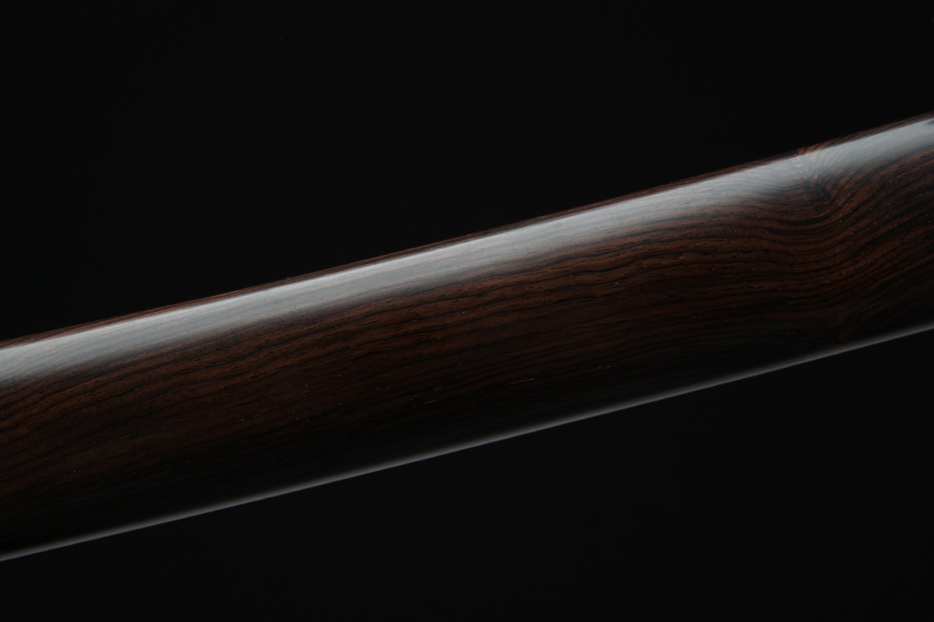 Wood grain surface of Loong War katana saya.