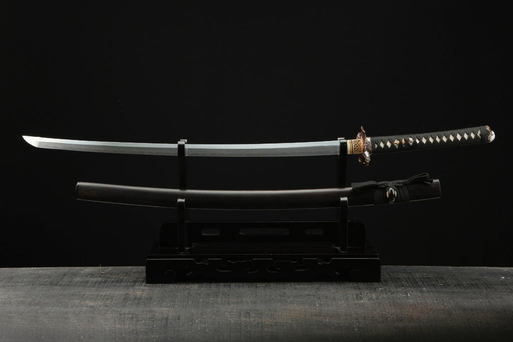 Full display of the Lotus katana featuring a Damascus steel blade and k
oshirae.