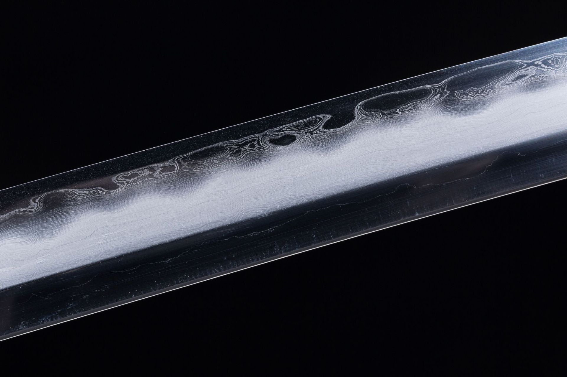 Detailed view of the san-mai forging on a Meditation katana blade.