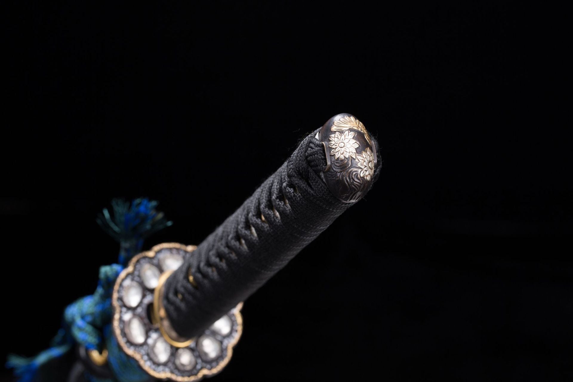 Meditation katana kashira floral pattern close-up.
