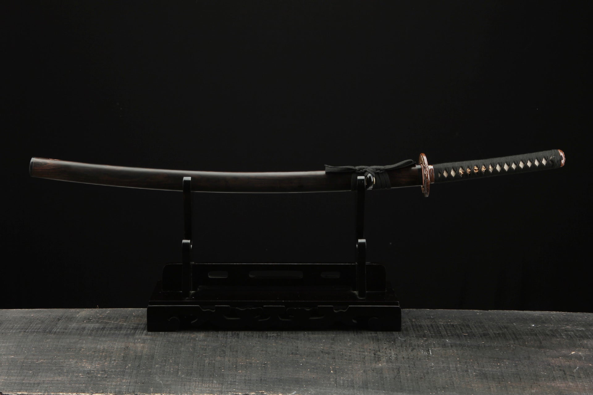 Full display of the Mountain Lord katana on a stand, showcasing the complete koshirae including handle, tsuba, and scabbard.