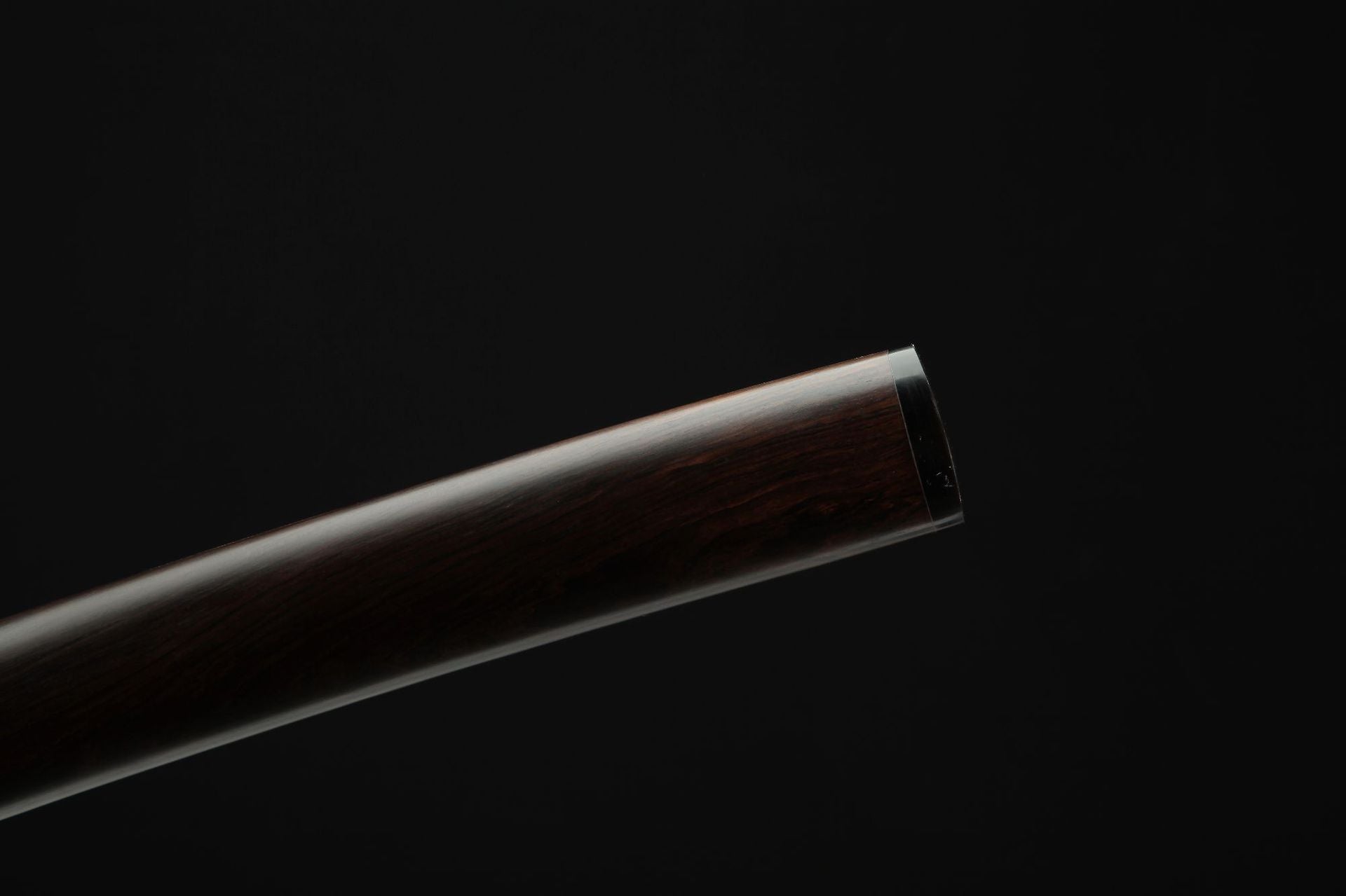 Close-up view of the kojiri on the Mountain Lord katana, highlighting the ebony material and craftsmanship.