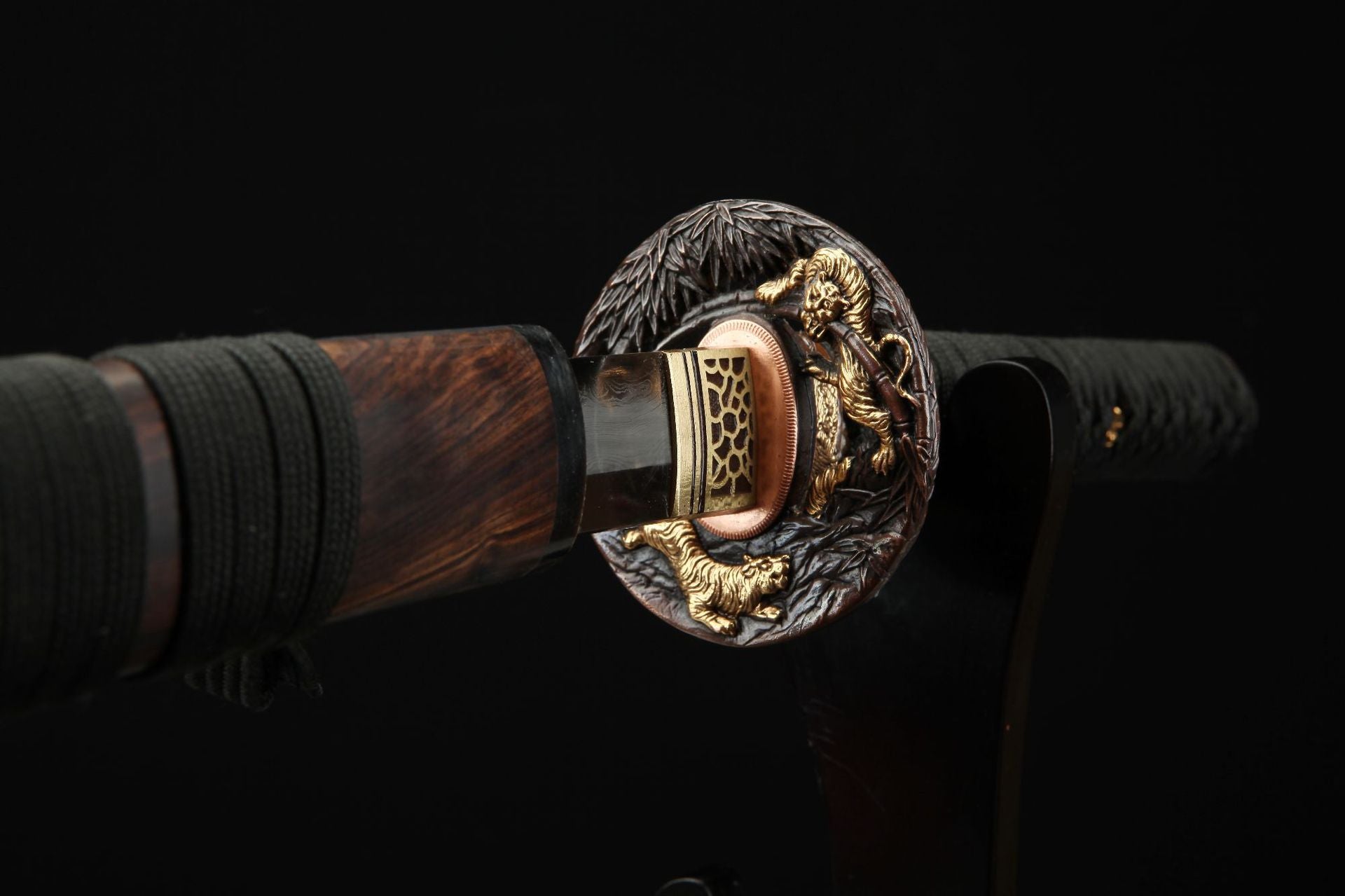 Detailed view of the Mountain Lord katana's seppa and tsuba, featuring intricate tiger carvings and craftsmanship.