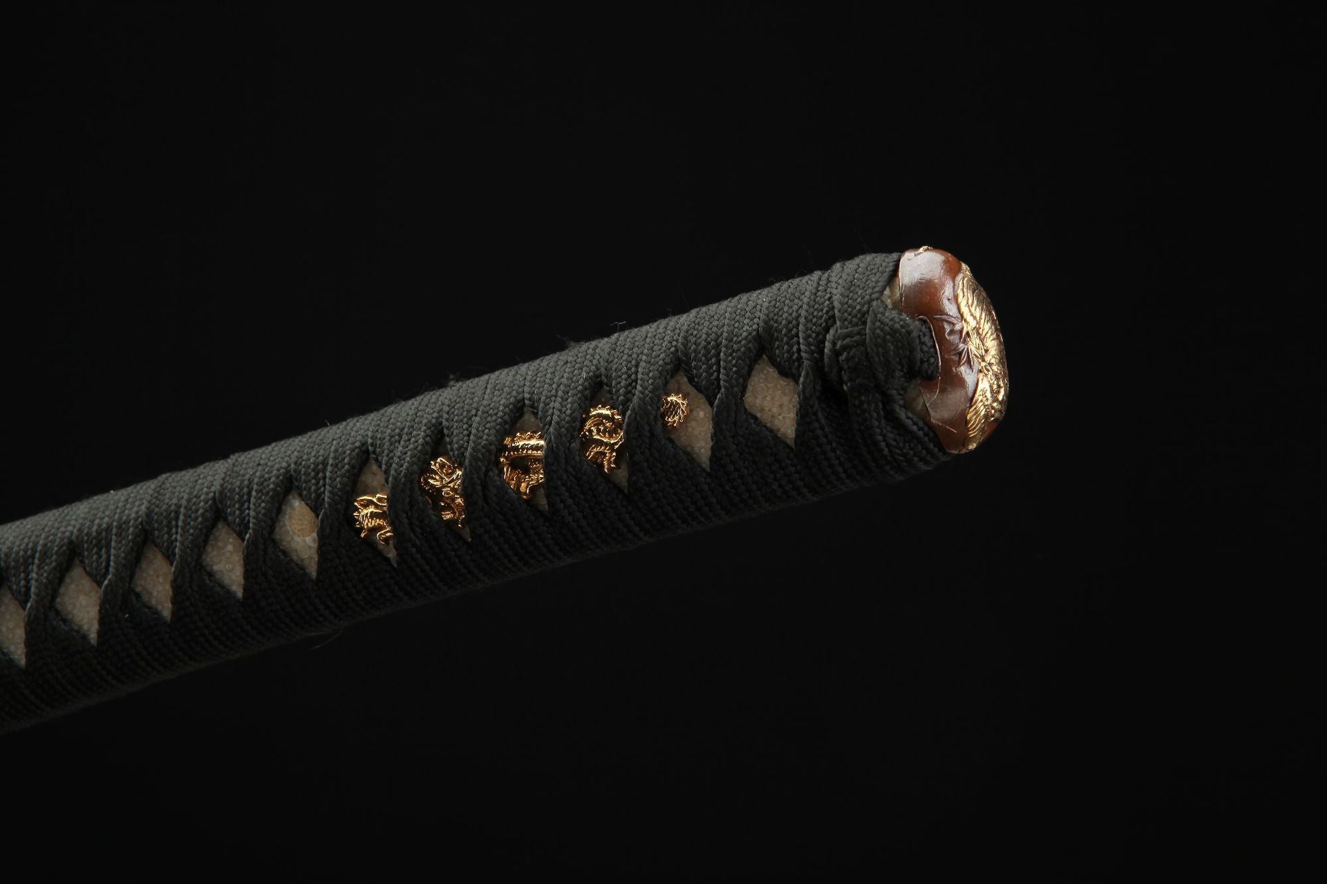 Detailed view of the Mountain Lord katana tsuka showing the tightly wrapped tsuka-maki and metal fittings.