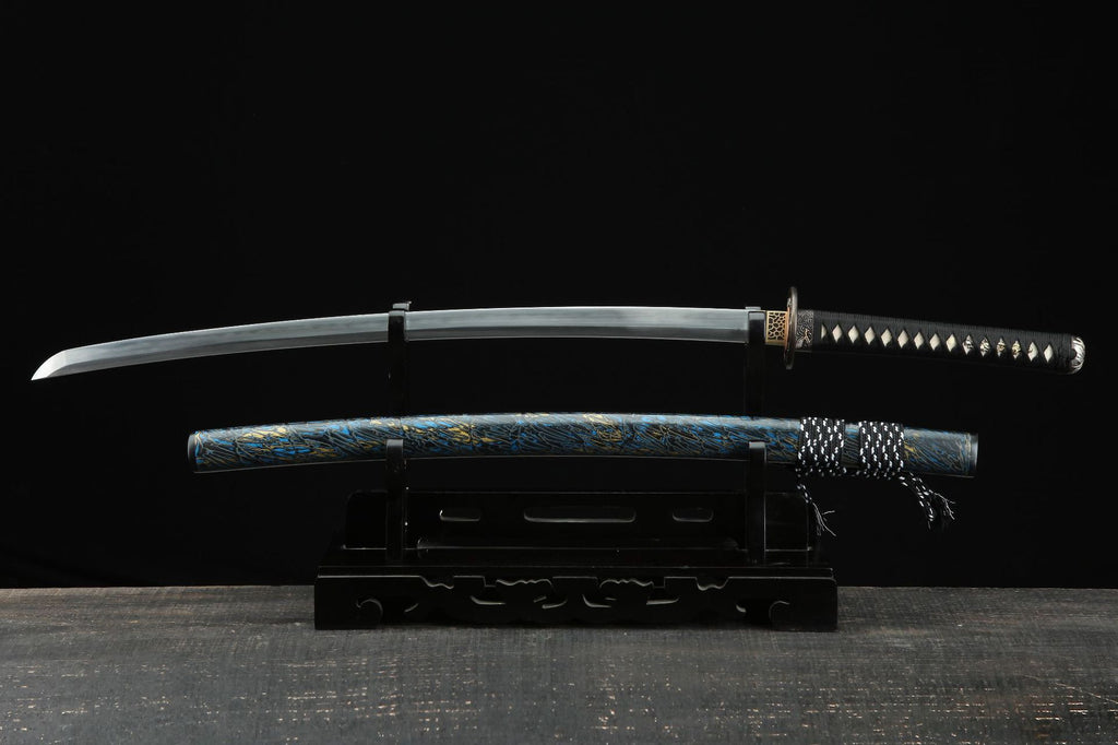 Full view of the Seiryu katana with a unique blue and gold patterned saya and a sharp, curved blade, displayed on a black wooden stand.