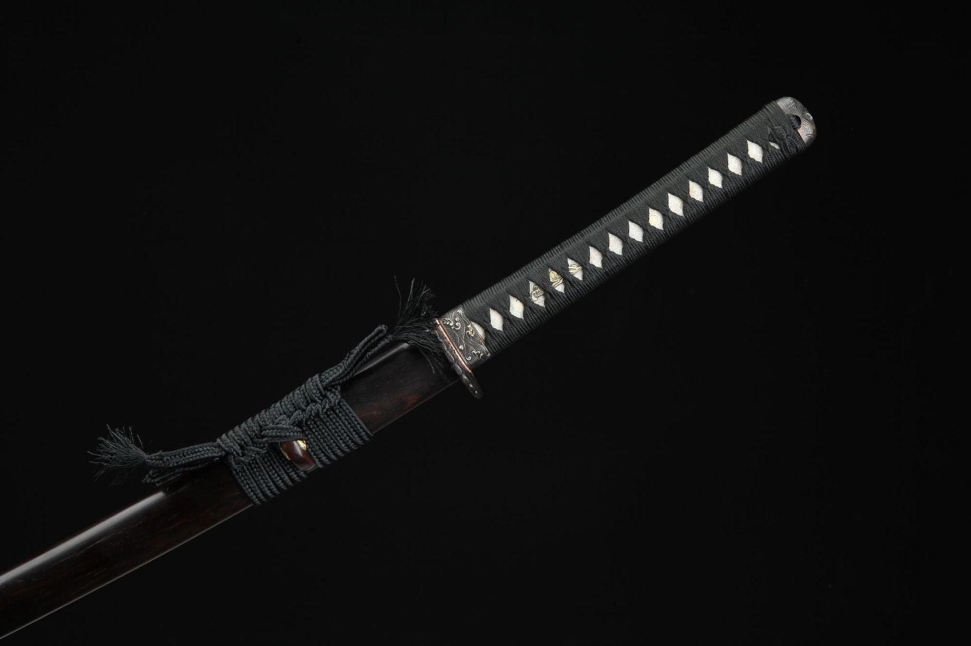 Close up of the Sunflower Ebony samurai sword handle featuring black cord wrap and white ray skin