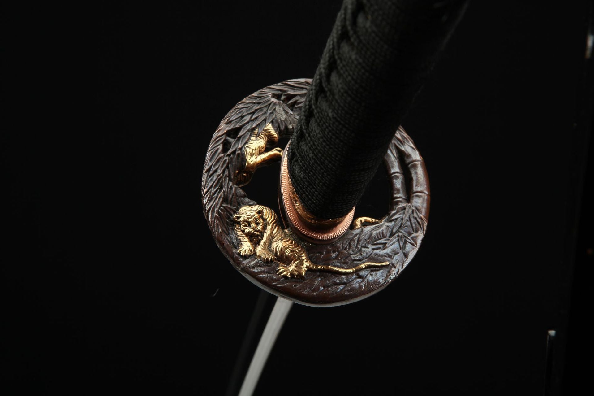 Reverse side view of the Mountain Lord katana's tsuba with detailed tiger carving, highlighting the artistry.