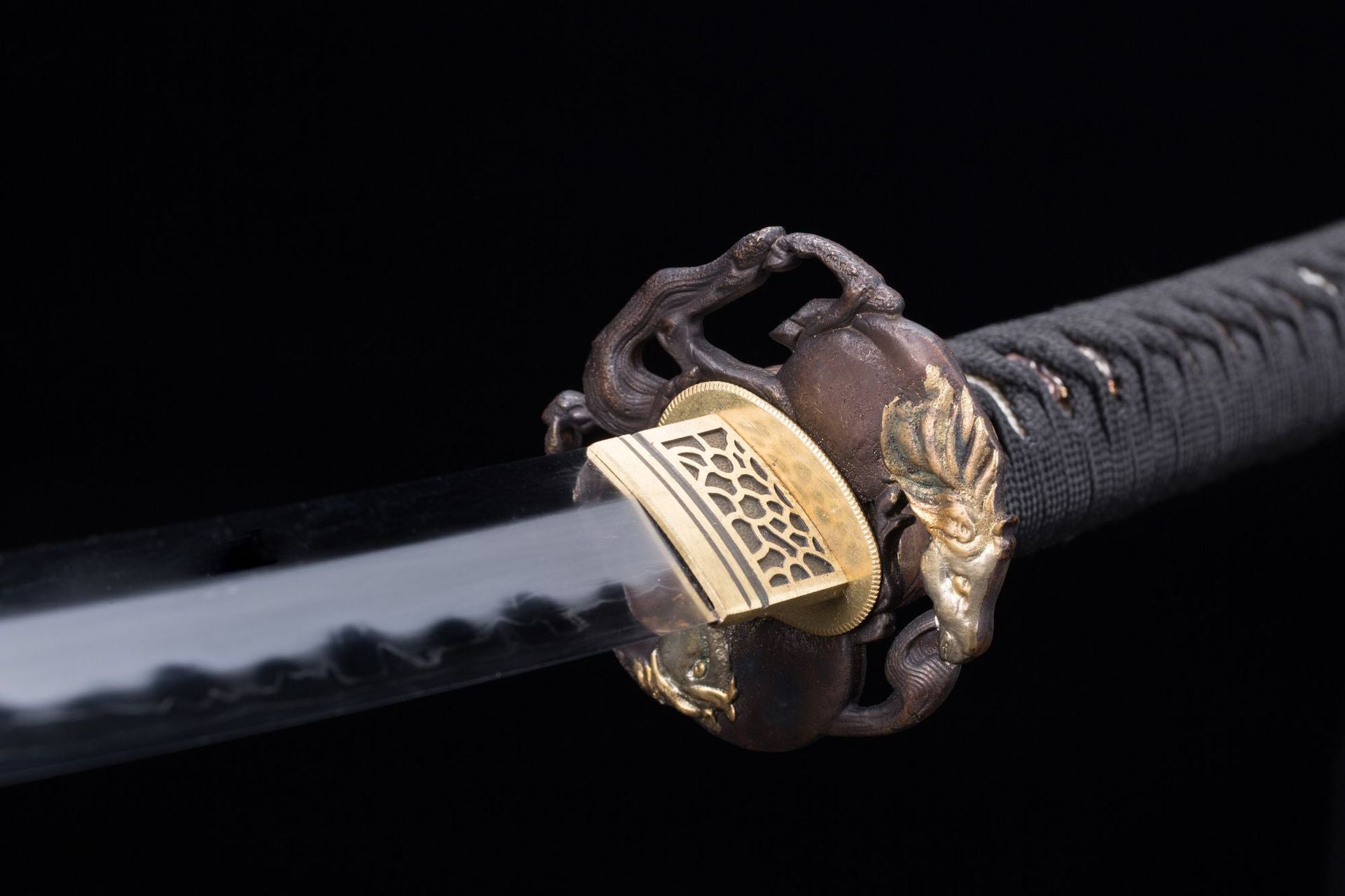Close-up of a Wild Horse katana tsuba, showcasing detailed carvings and a unique design.