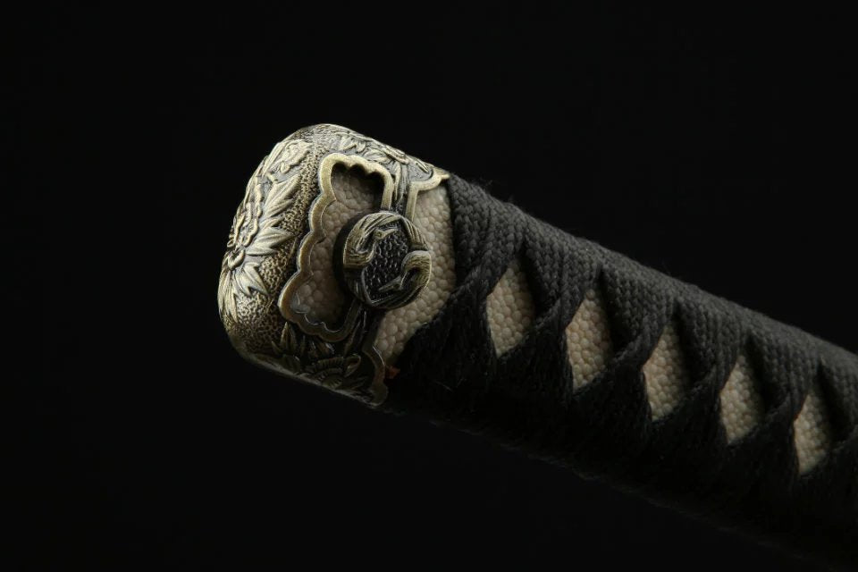 A vintage komainu kashira sword fitting, showcasing intricate Japanese artistry and traditional craftsmanship.