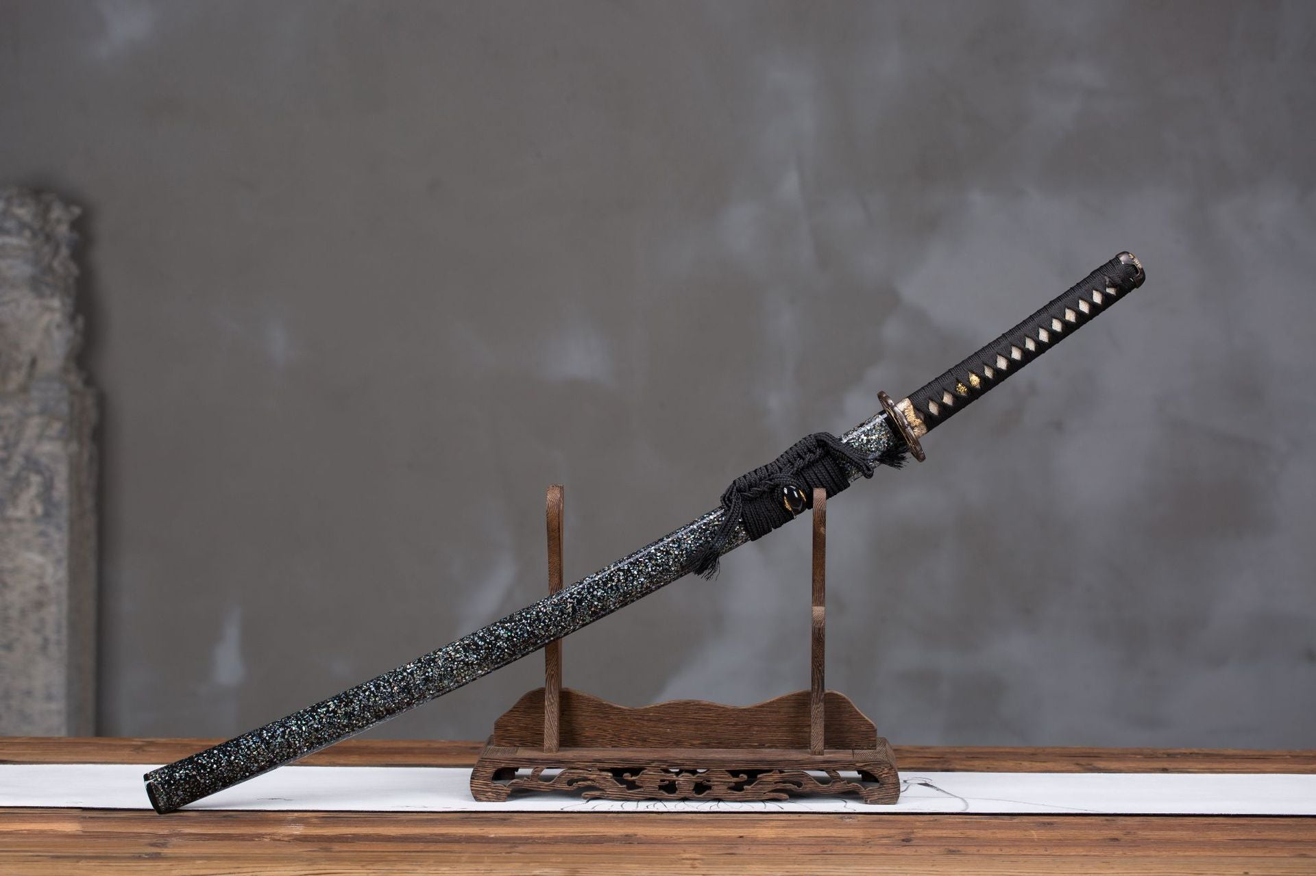 Complete Wild Horse samurai sword mounted on a wooden stand.